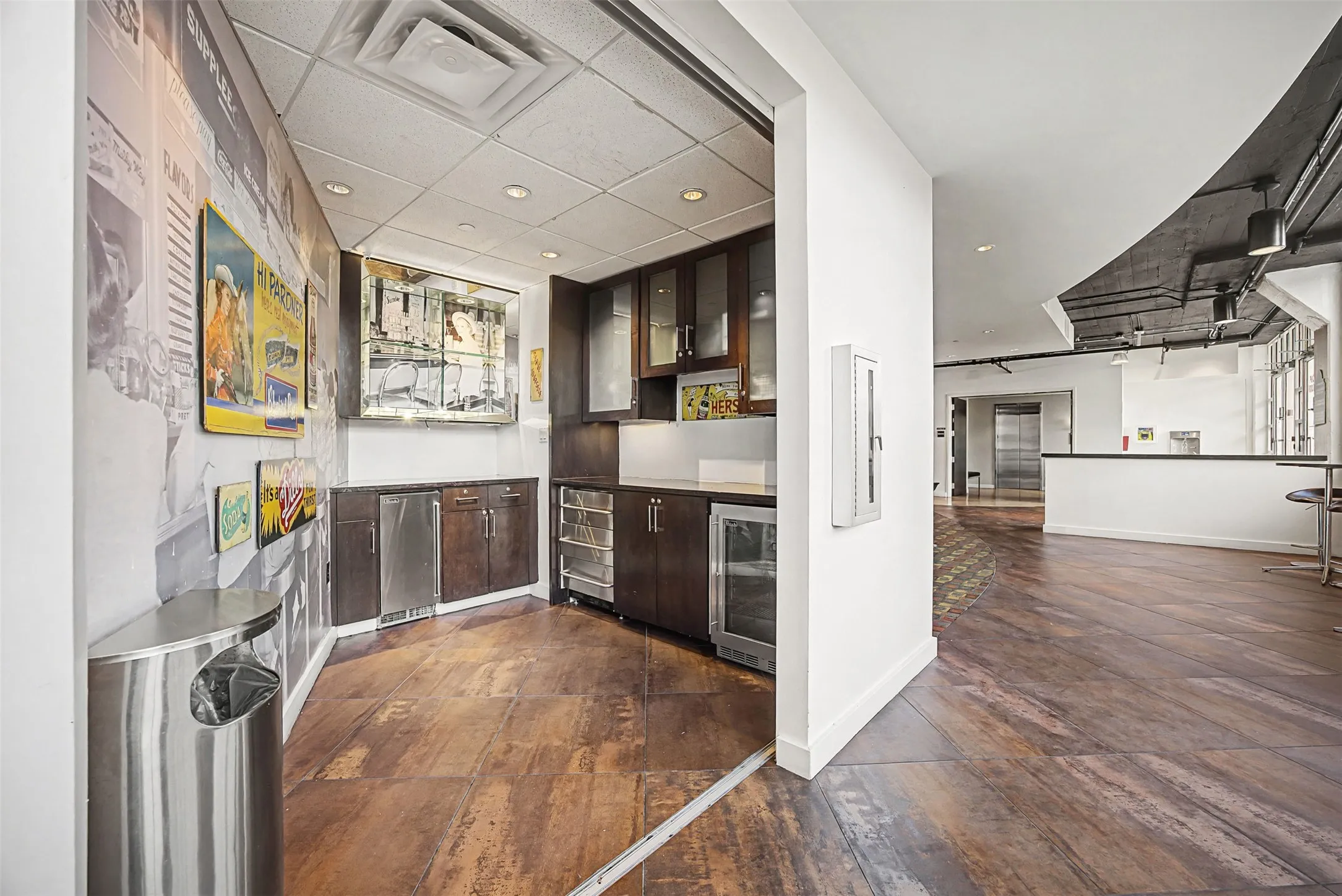 Community bar area featuring dark wood finish cabinetry, glass insert cabinets, recessed lighting, and wine cooler