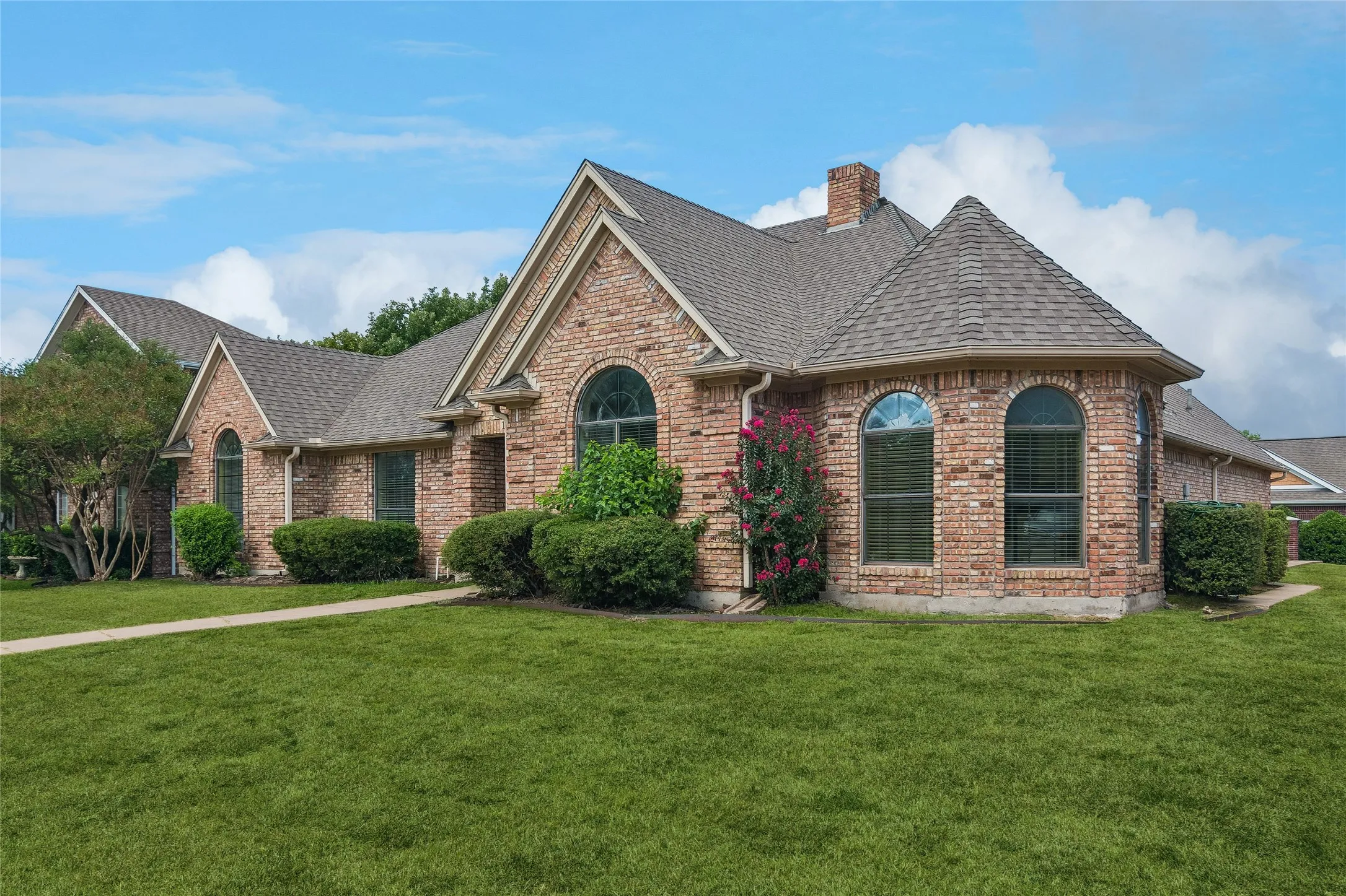 Brick exterior with an arched window, a gabled roof.