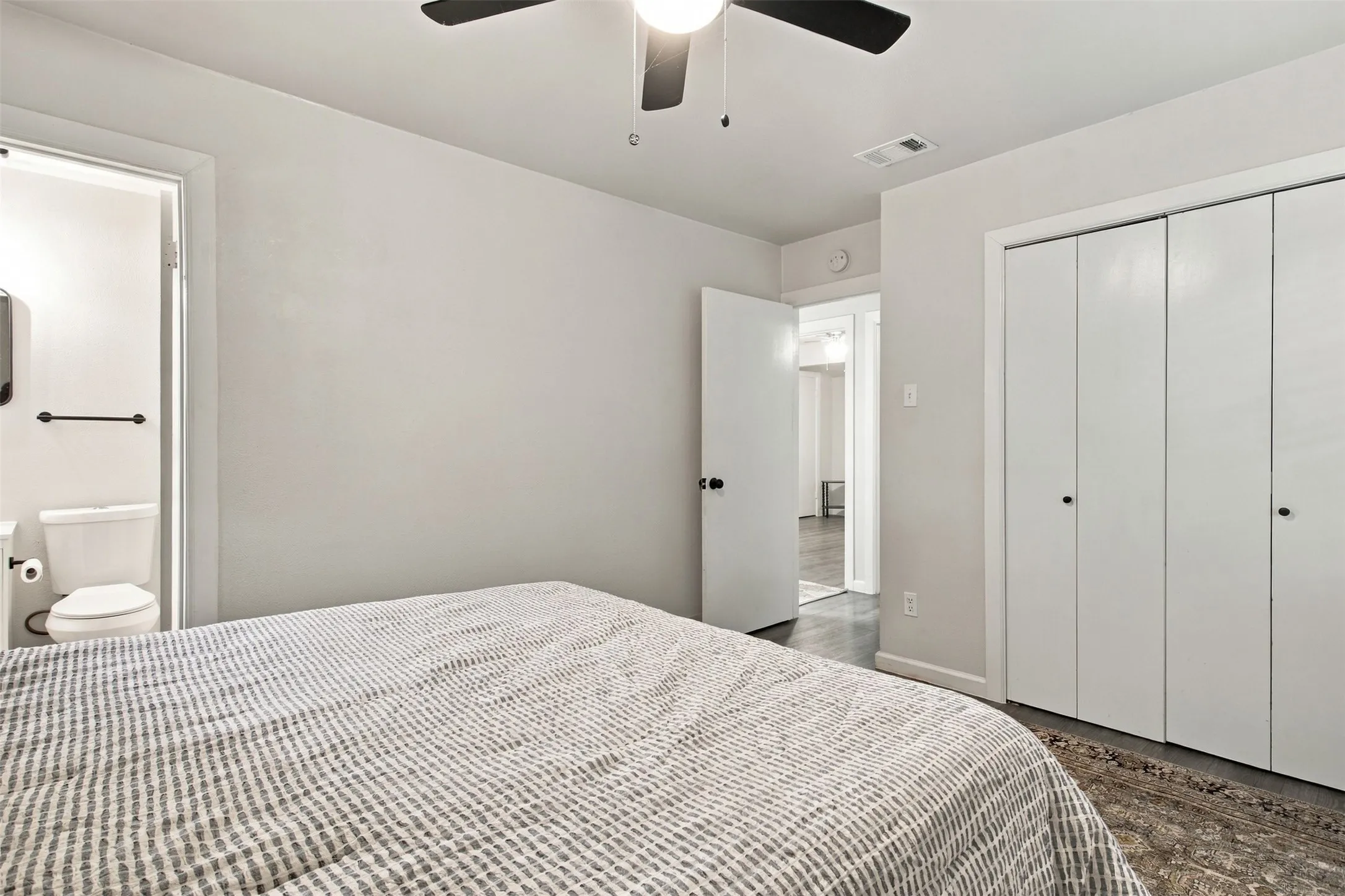 White walls complement the dark wood-finish flooring