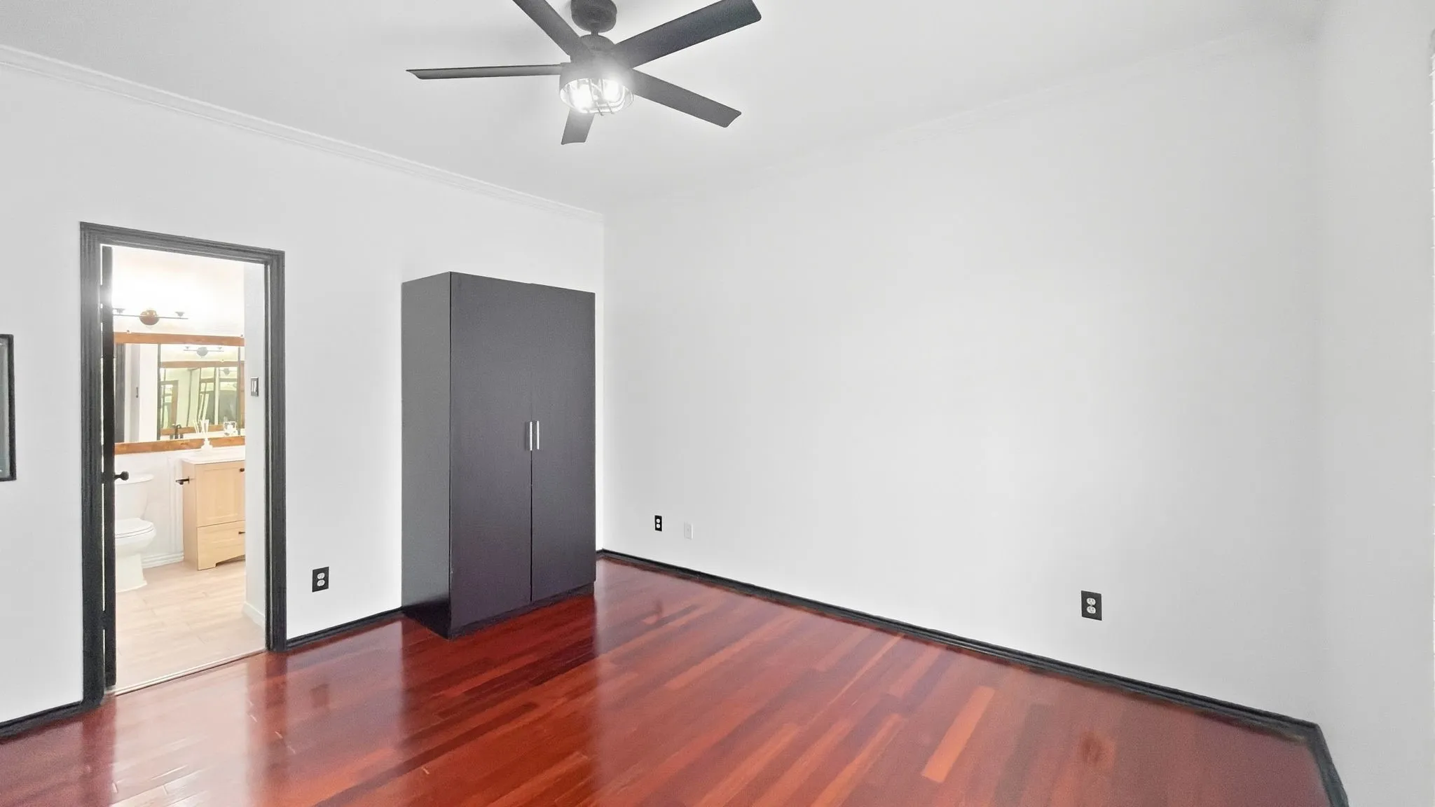 Hardwood flooring, painted walls, black ceiling fan, and recessed lighting