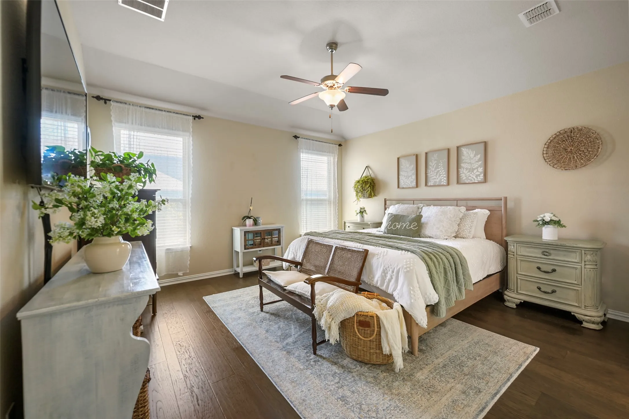 Wood-finish flooring, ceiling fan, and multiple windows with blinds
