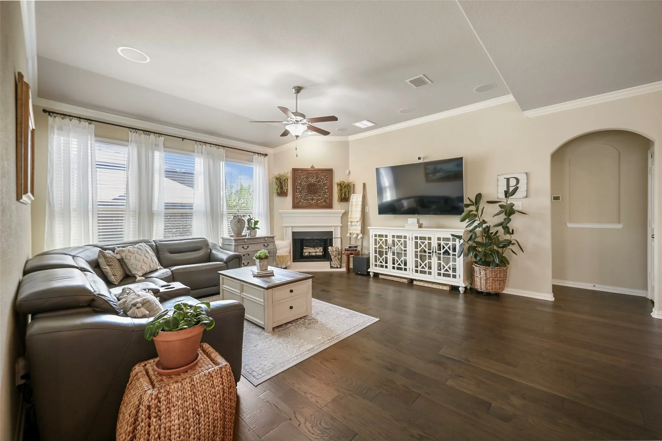Wood-finish flooring, recessed lighting, and a ceiling fan with light fixture