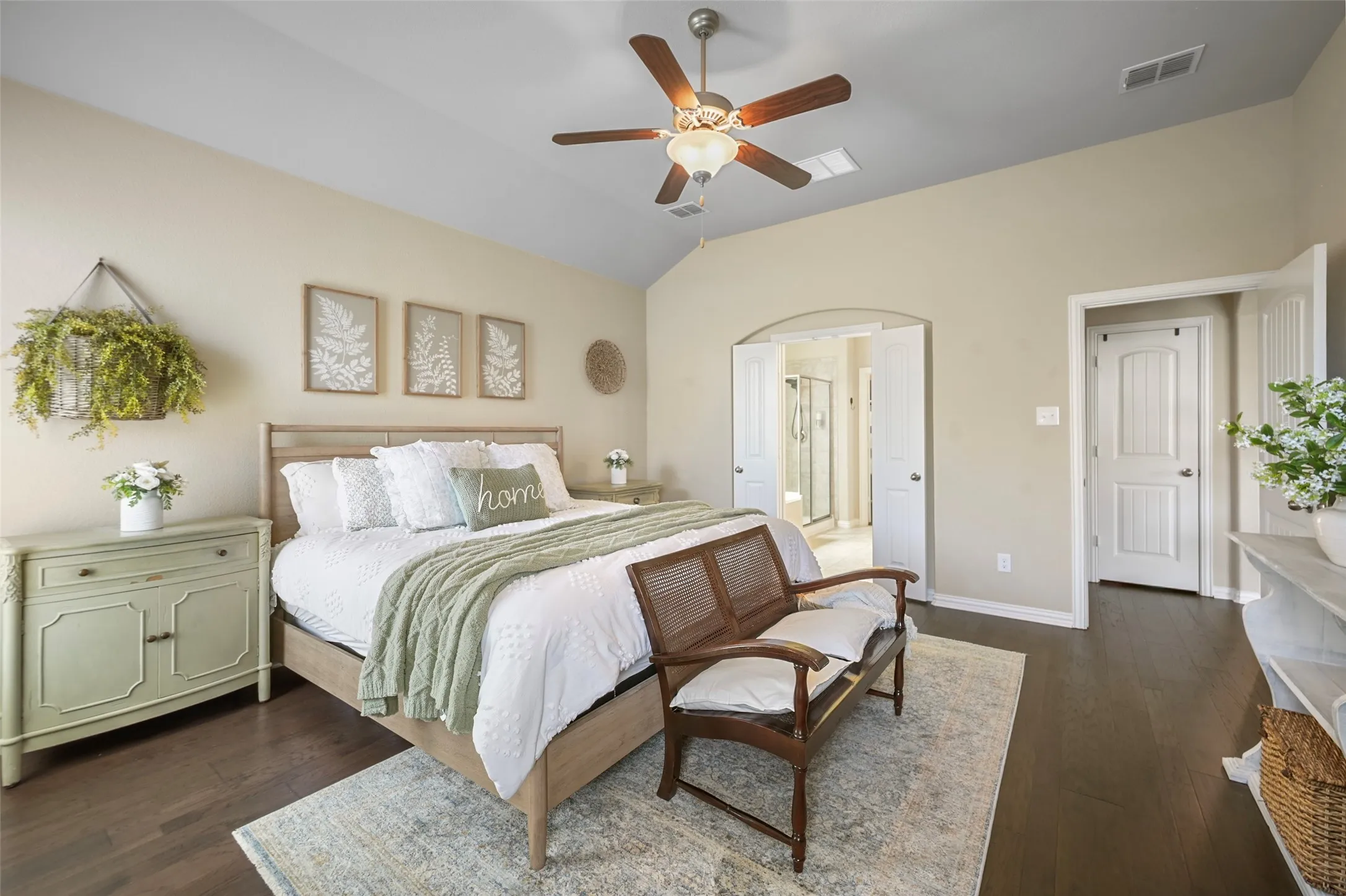 Vaulted ceiling with a ceiling fan, dark wood-finish flooring, and white paneled doors