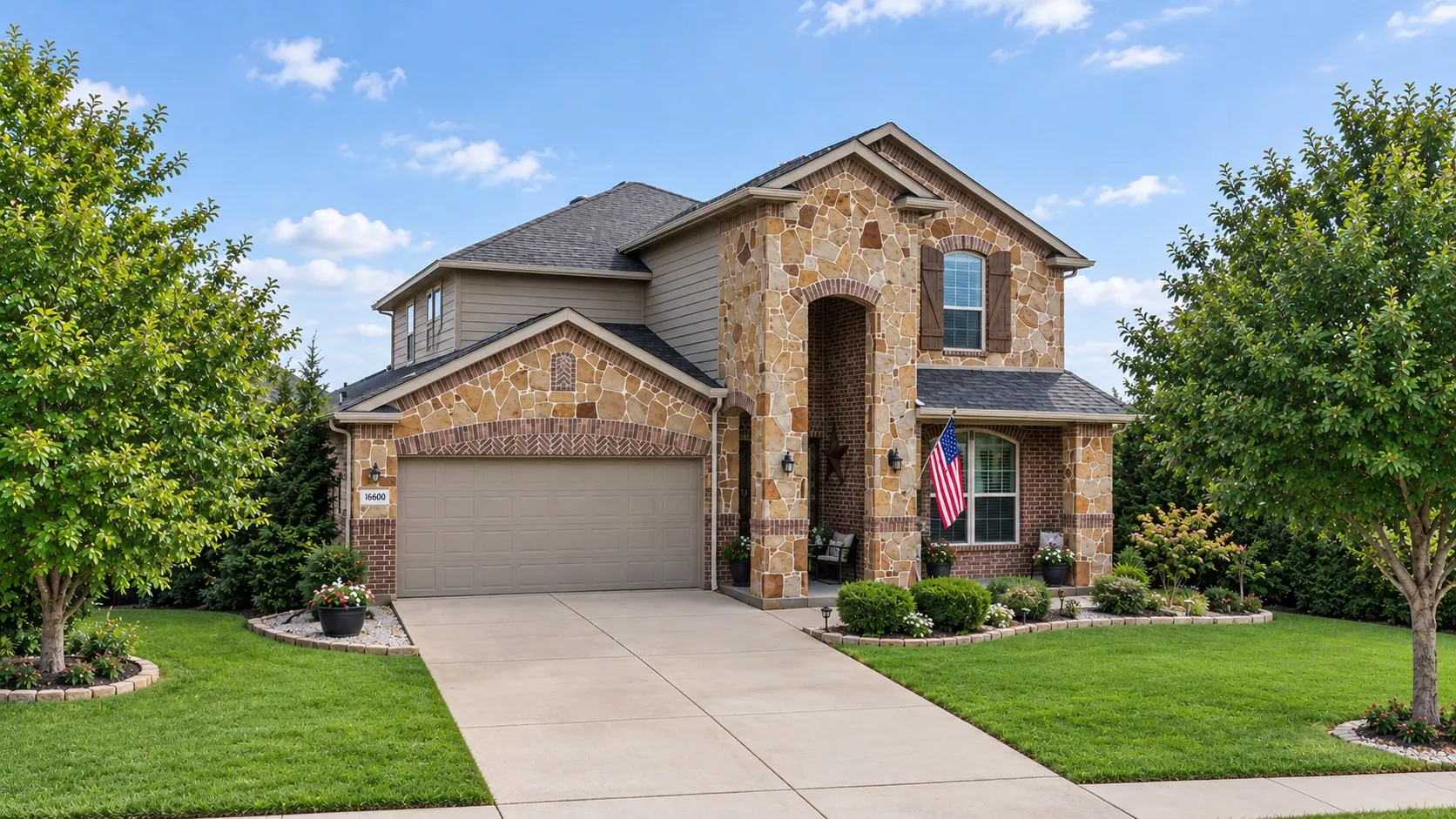 Stone and brick exterior with arched entryway and covered porch