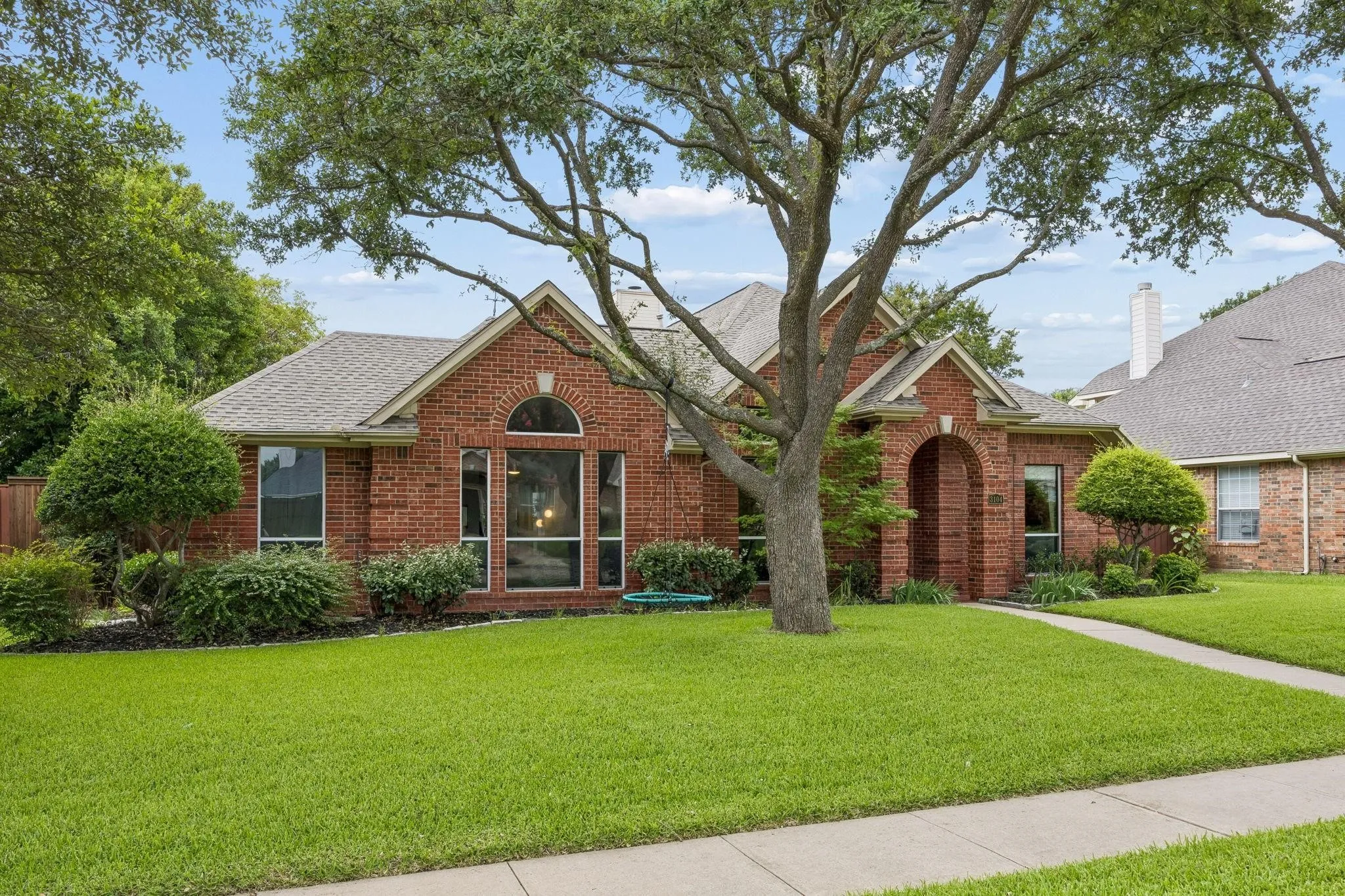 Brick exterior with arched entry and transom window