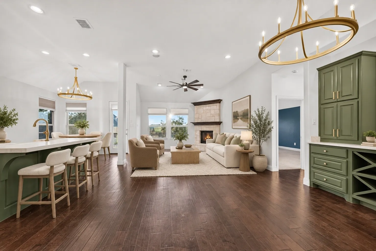 Dark wood-finish flooring, vaulted ceilings, and a stone-clad fireplace