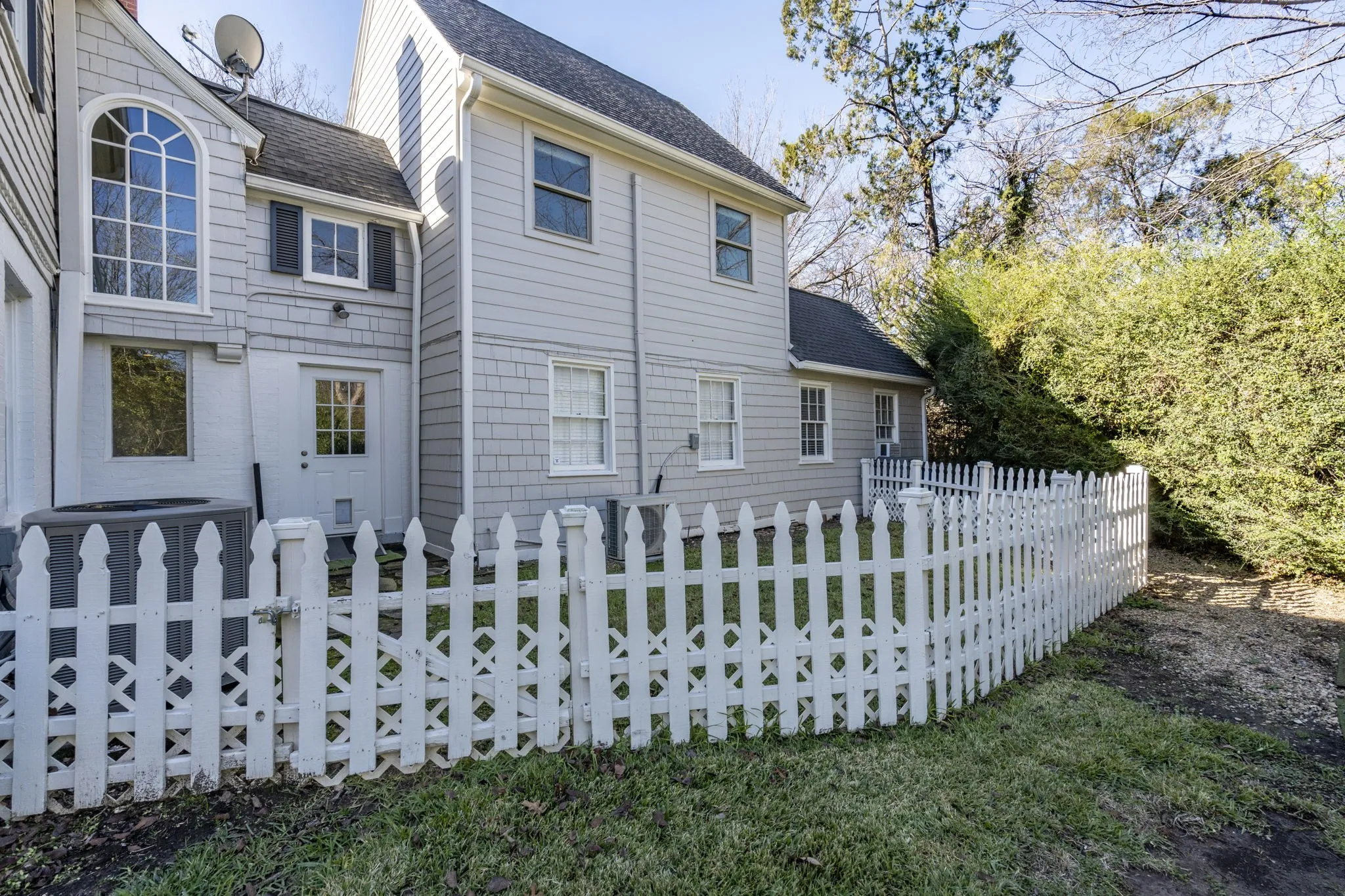 Rear view of house featuring a shingled roof