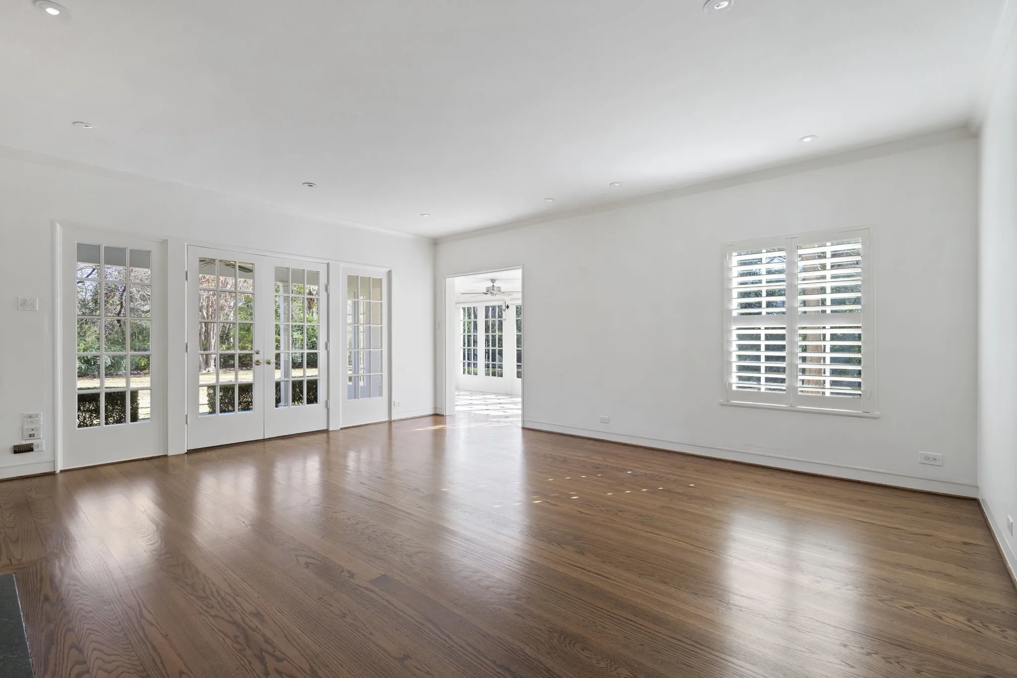 Spare room with french doors, dark wood-style floors, crown molding, and recessed lighting