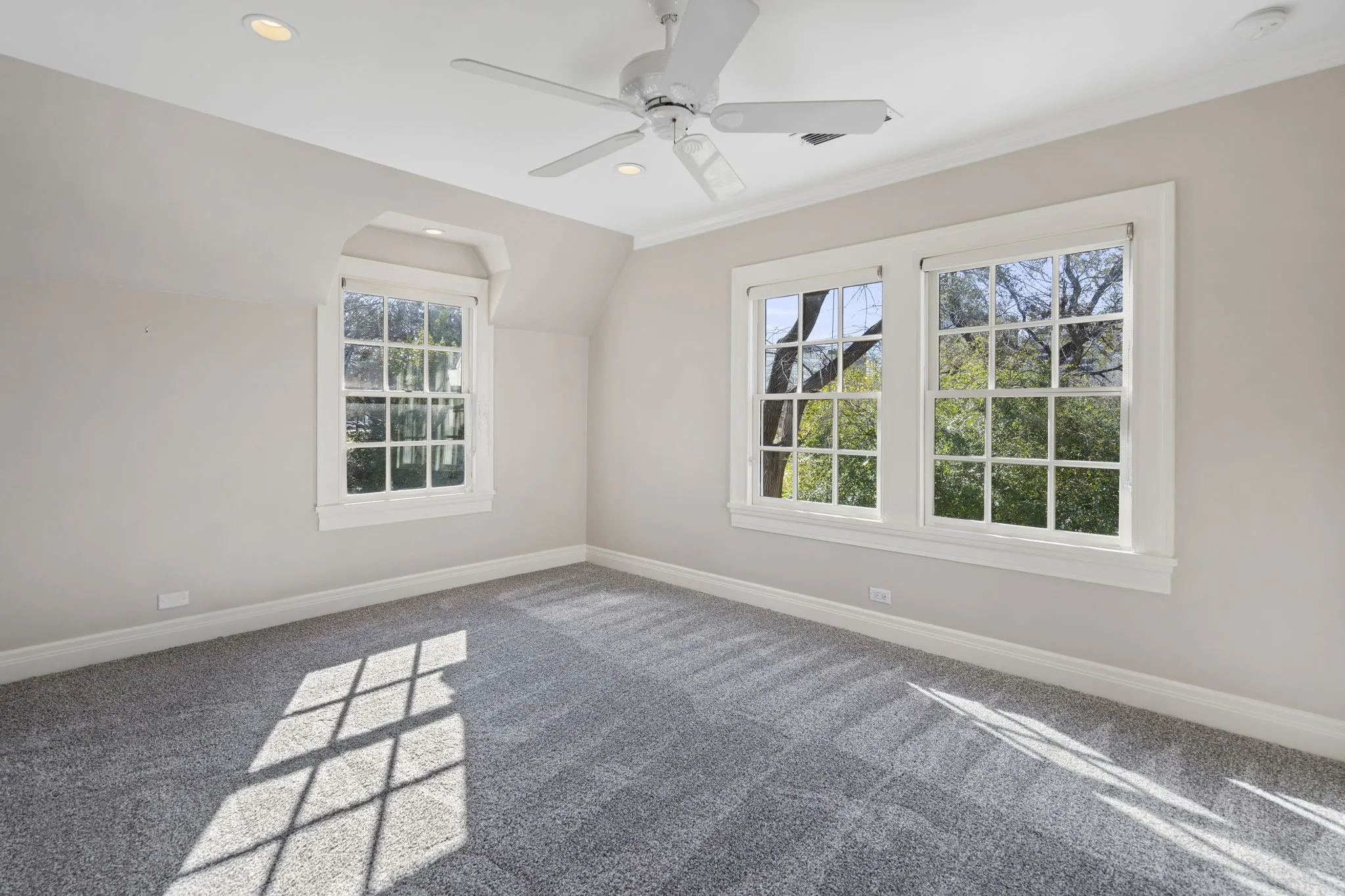 Carpeted spare room featuring recessed lighting, lofted ceiling, and a ceiling fan