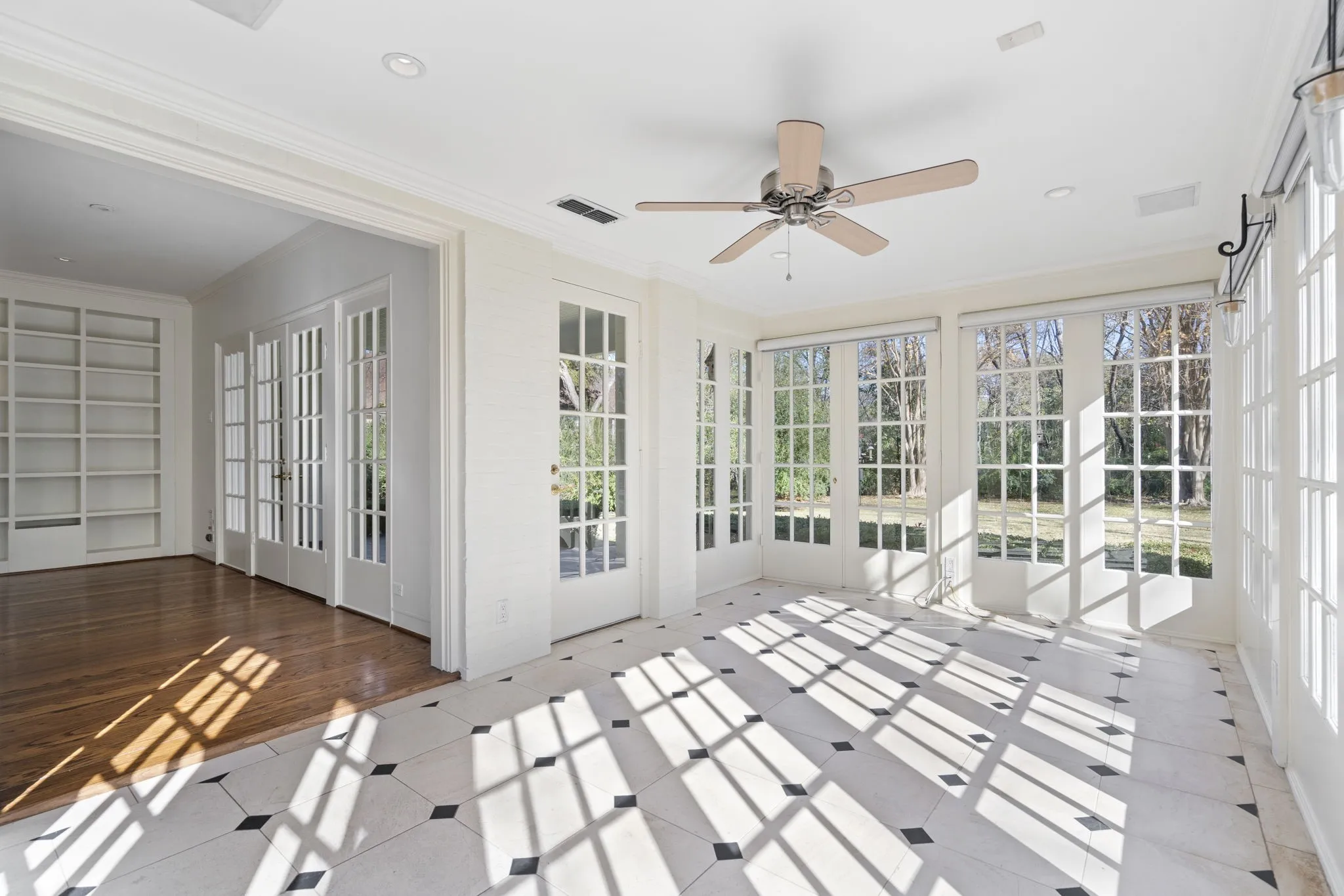 Unfurnished sunroom with recessed lighting, crown molding, tile patterned floors, and french doors