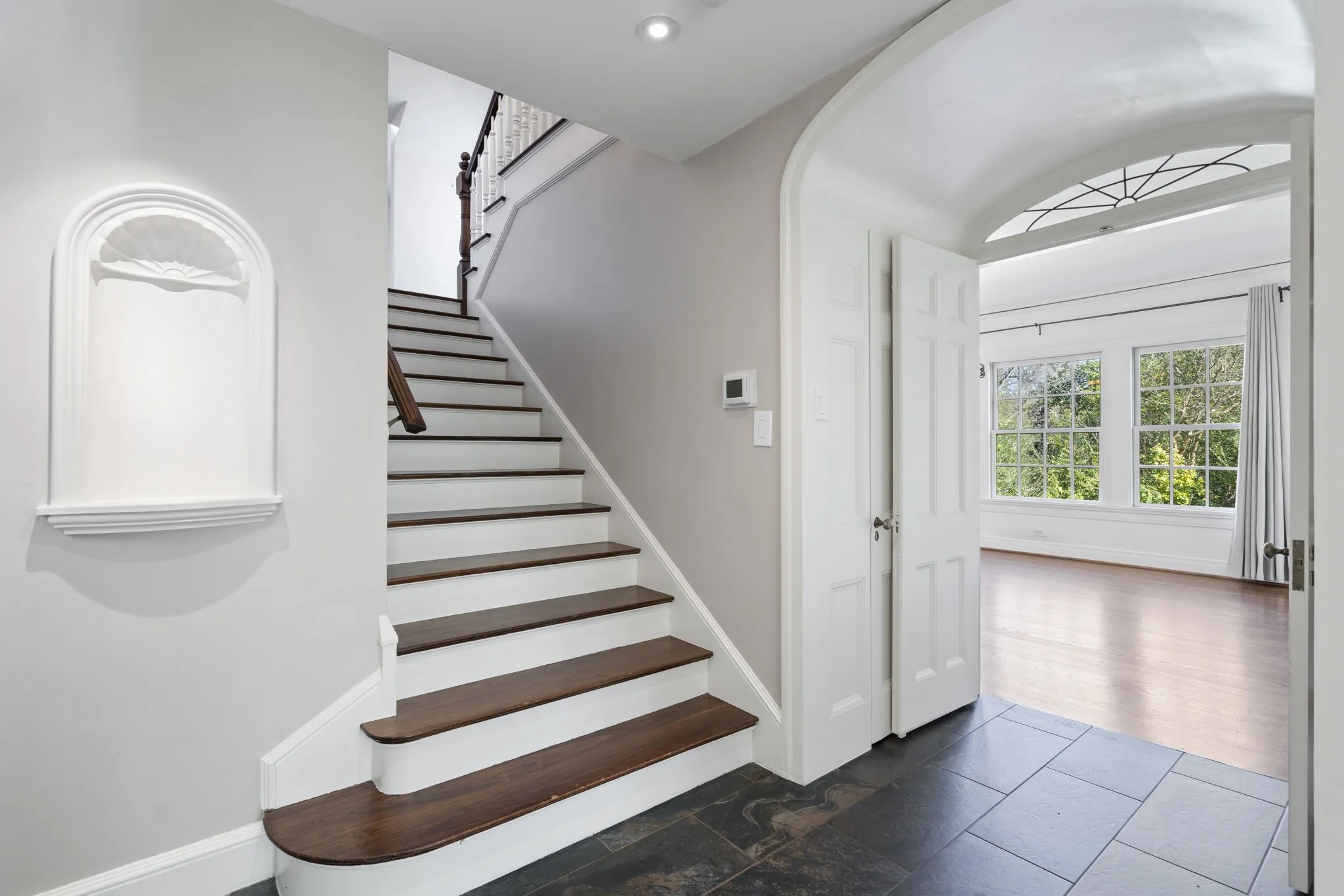 Stairs with arched walkways and baseboards