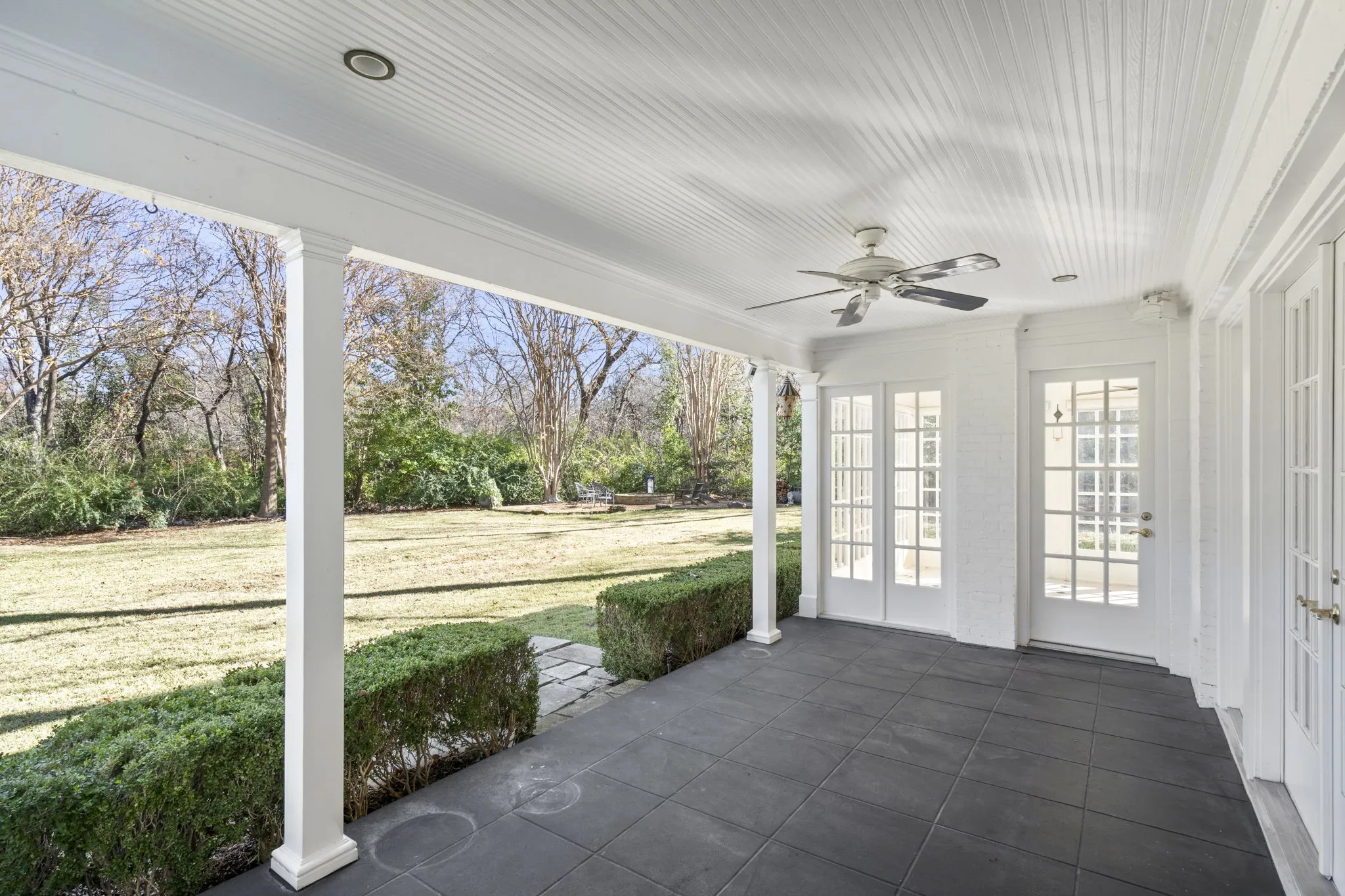 Unfurnished sunroom featuring a ceiling fan and french doors