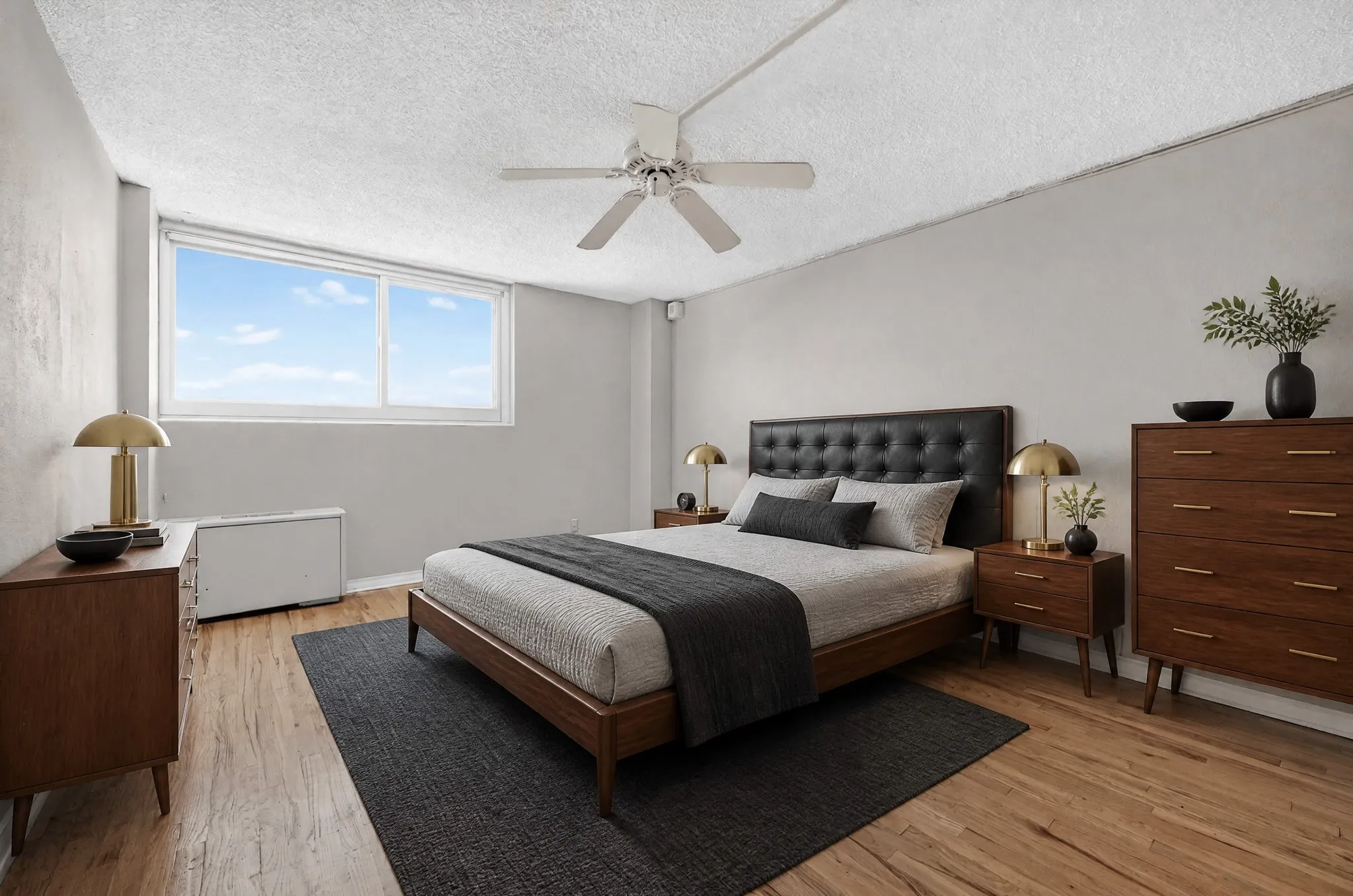 AI Generated.
Wide window, wood-finish flooring, ceiling fan, neutral wall tones, and overhead lighting