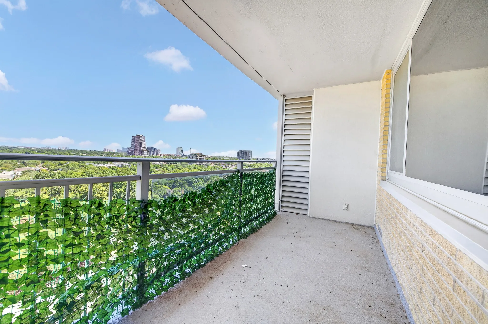 Balcony with concrete flooring and a metal railing