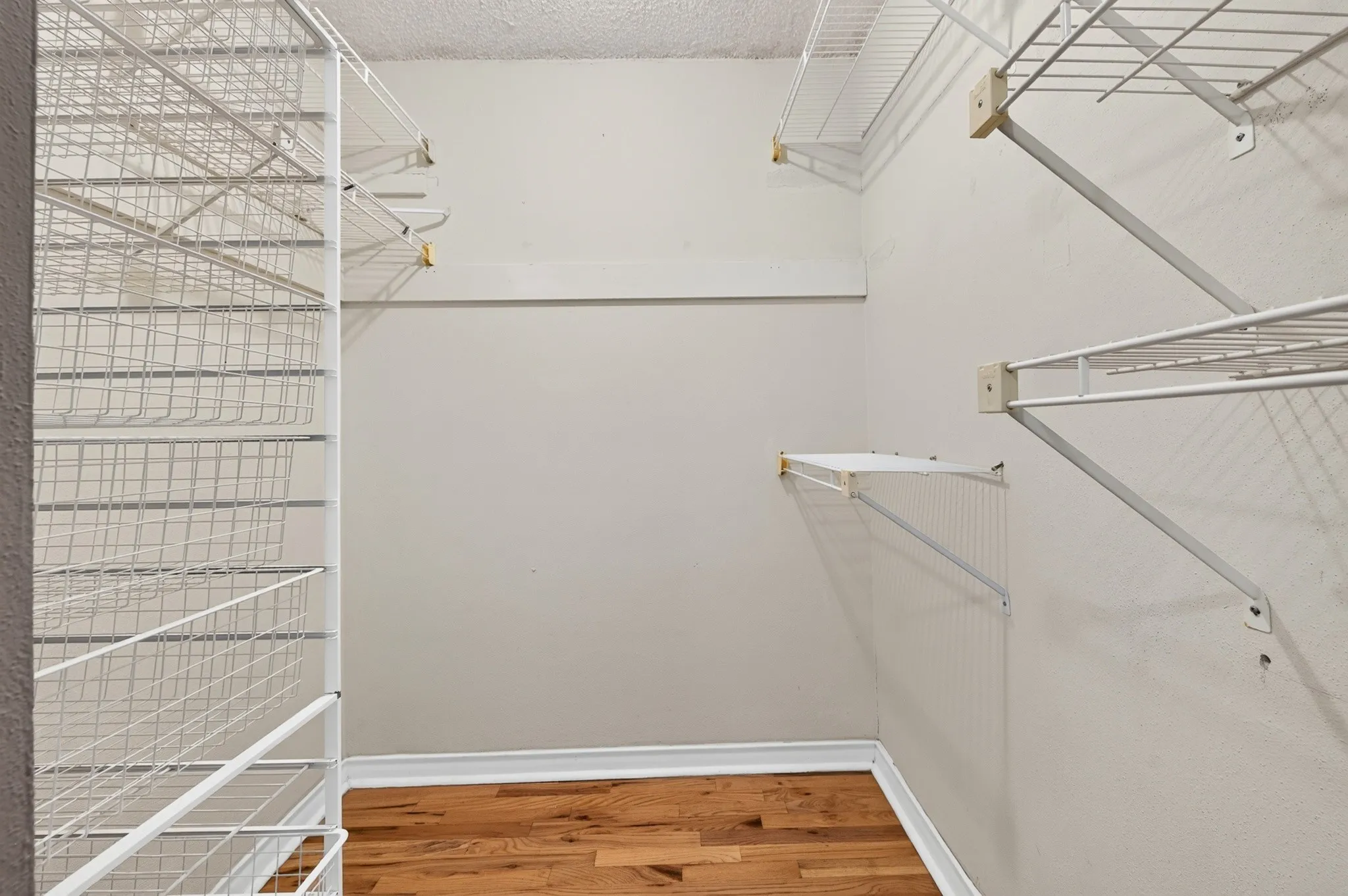 Hardwood flooring paired with white wire shelving