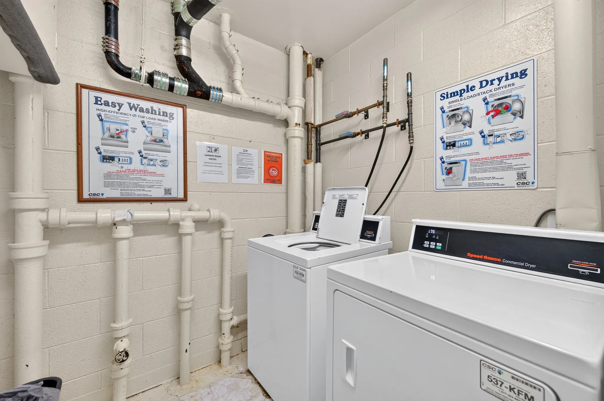 Dedicated laundry area featuring a commercial washer and dryer