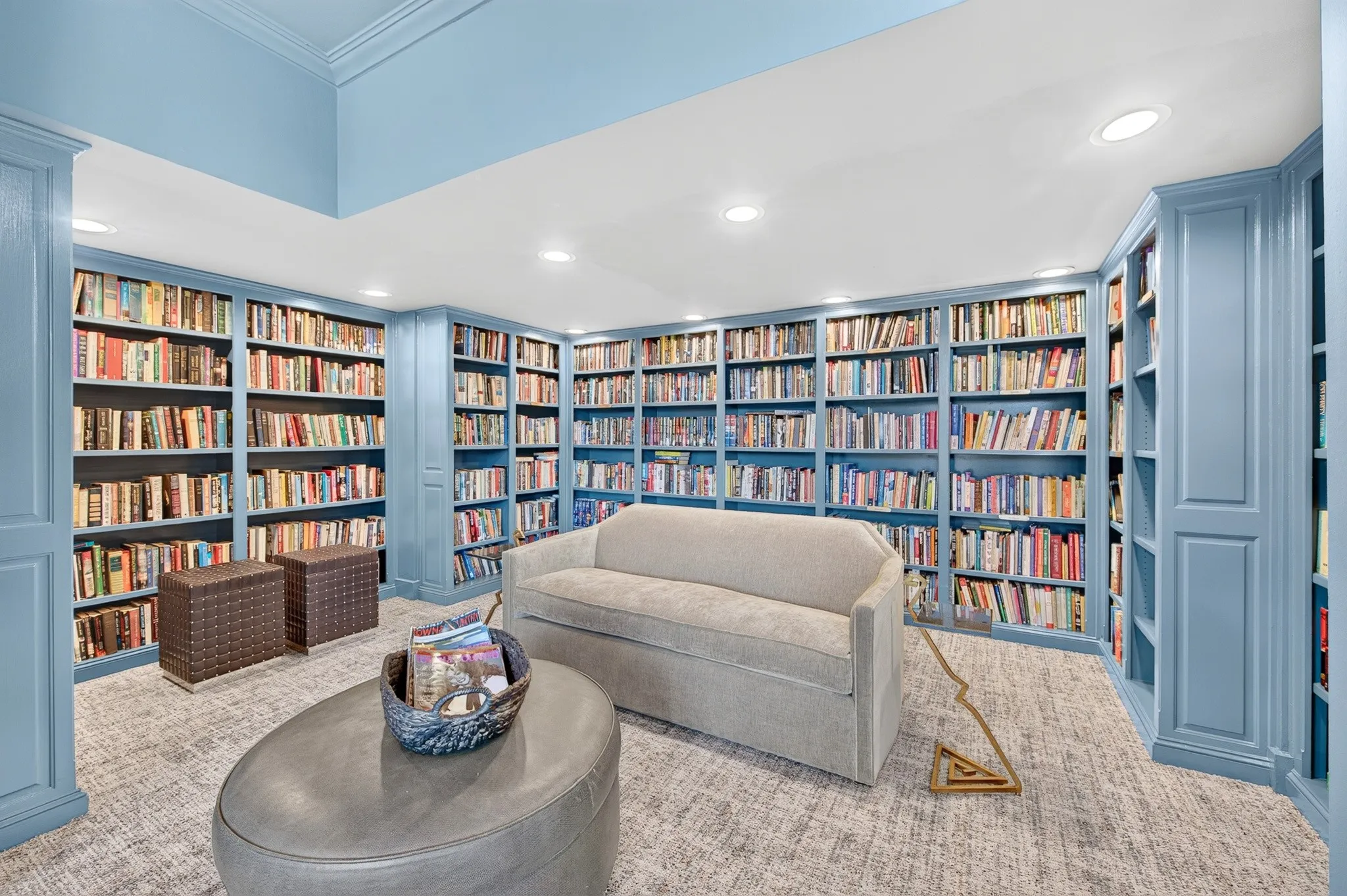 Custom built-in bookcases, recessed lighting, crown molding, and carpeted flooring