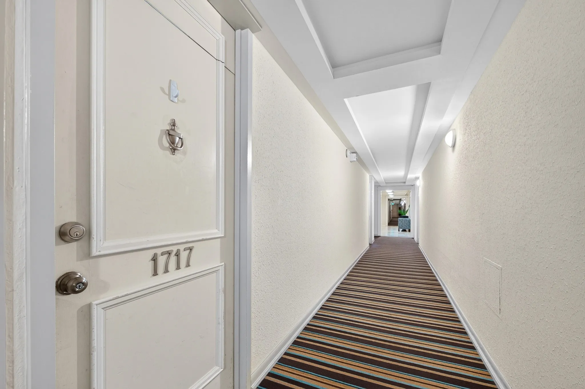 Entry door with panel detailing and bright door hardware