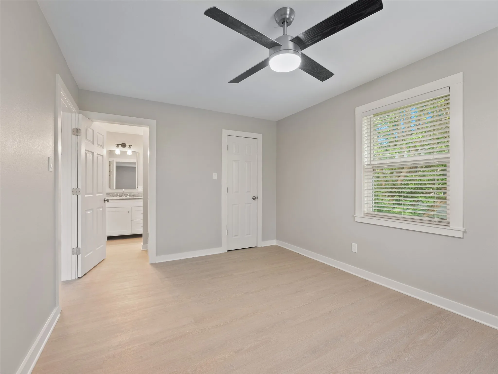 Light wood-finish flooring with white trim