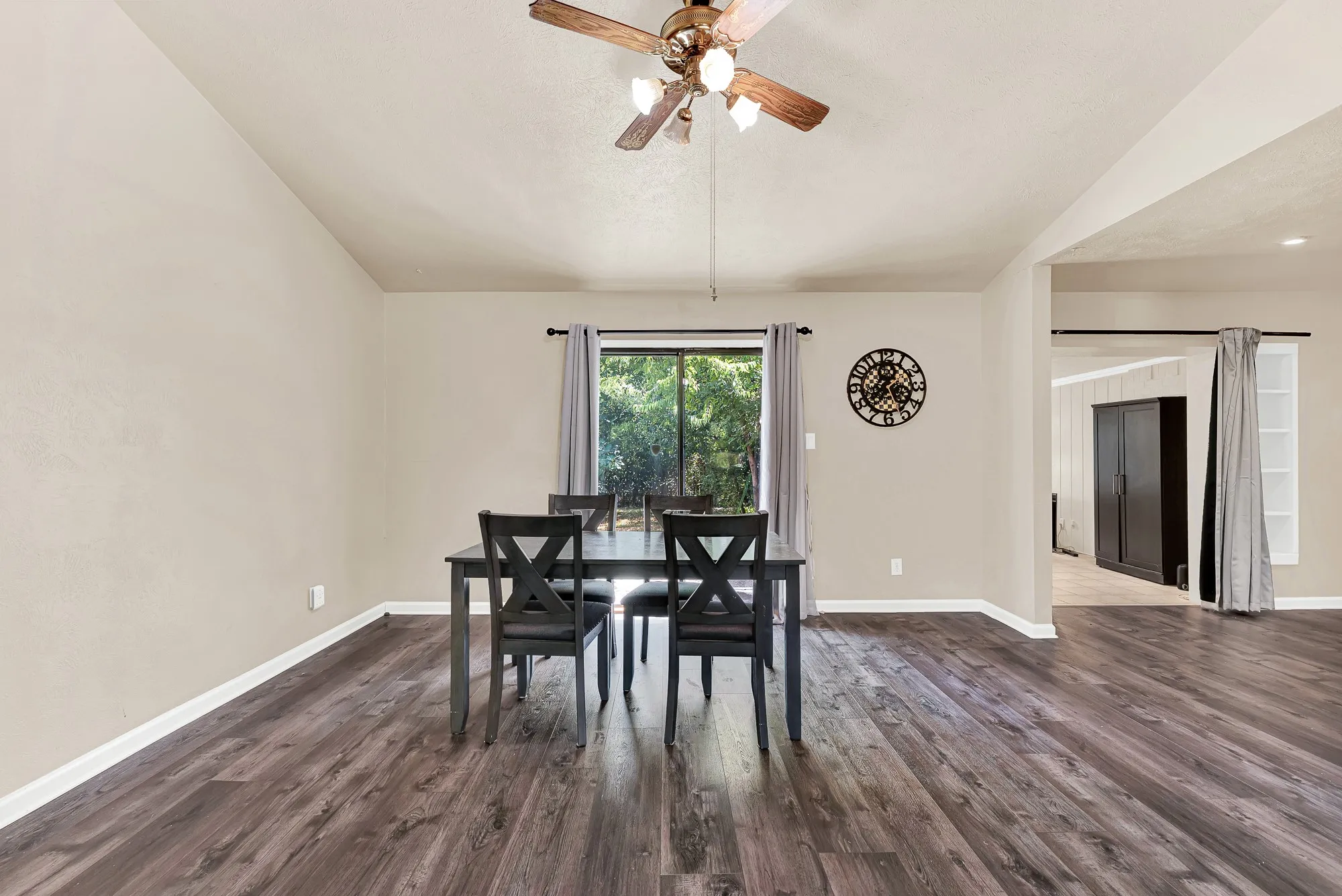 Wood-finish flooring, vaulted ceiling, and ceiling fan with lighting