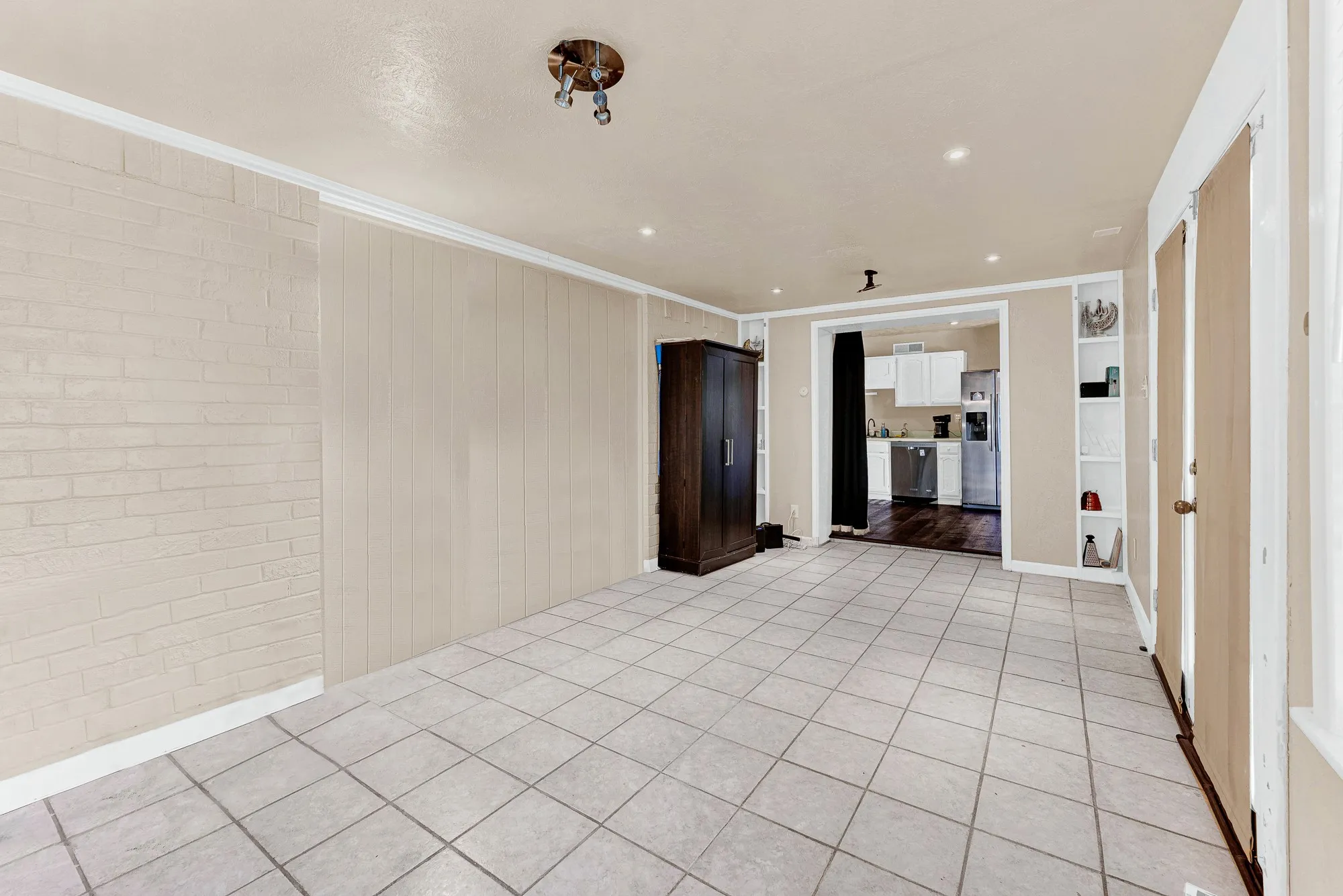 Vaulted ceilings, wood-finish flooring, and multiple ceiling fans