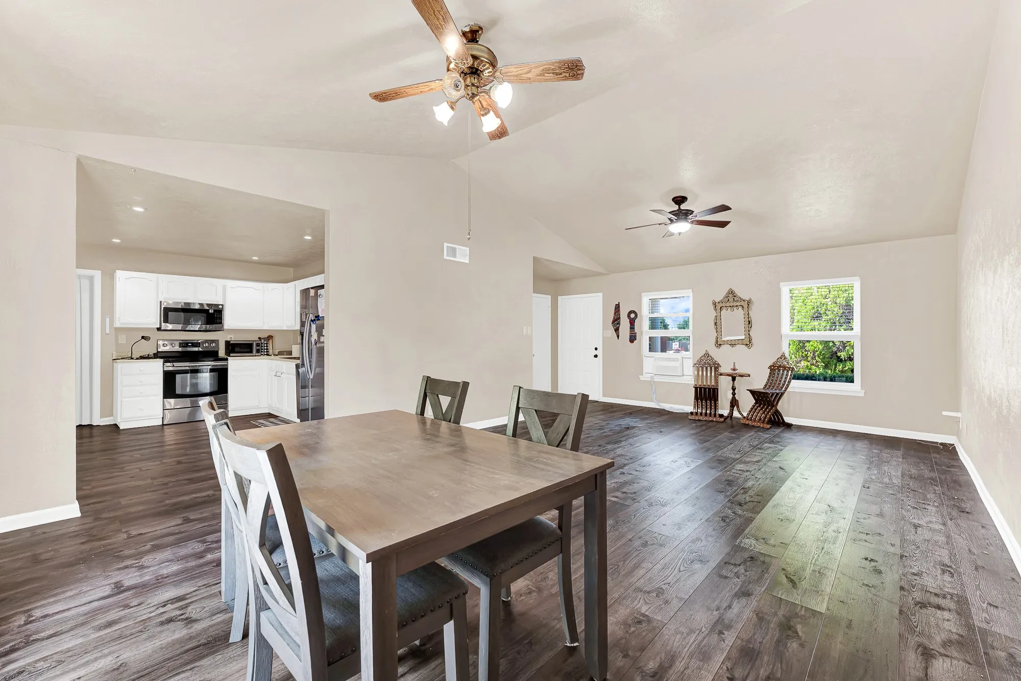 Wood-finish flooring, ceiling fan, white window blinds, and built-in closet