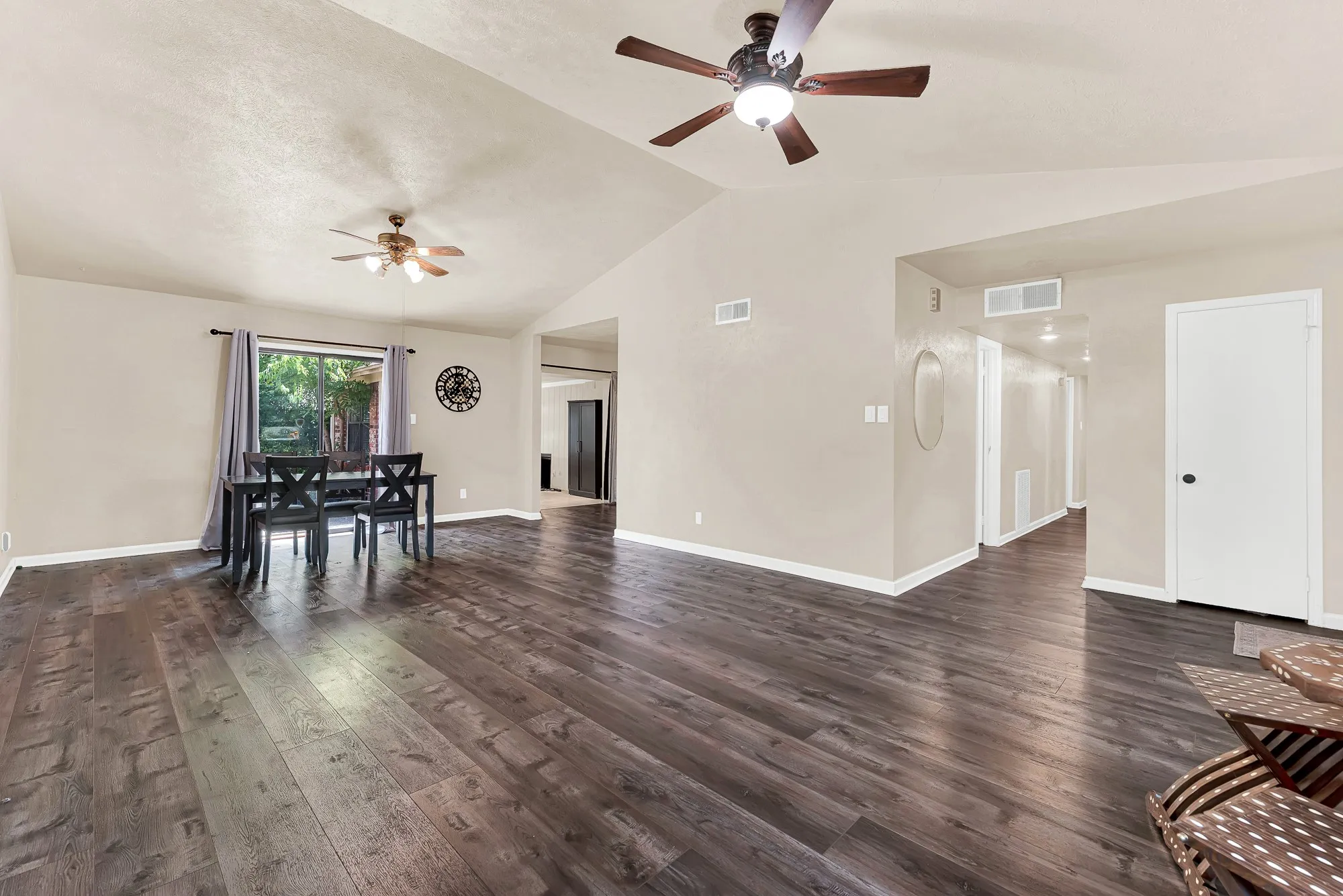 Vaulted ceiling, wood-finish flooring, recessed lighting, and ceiling fan