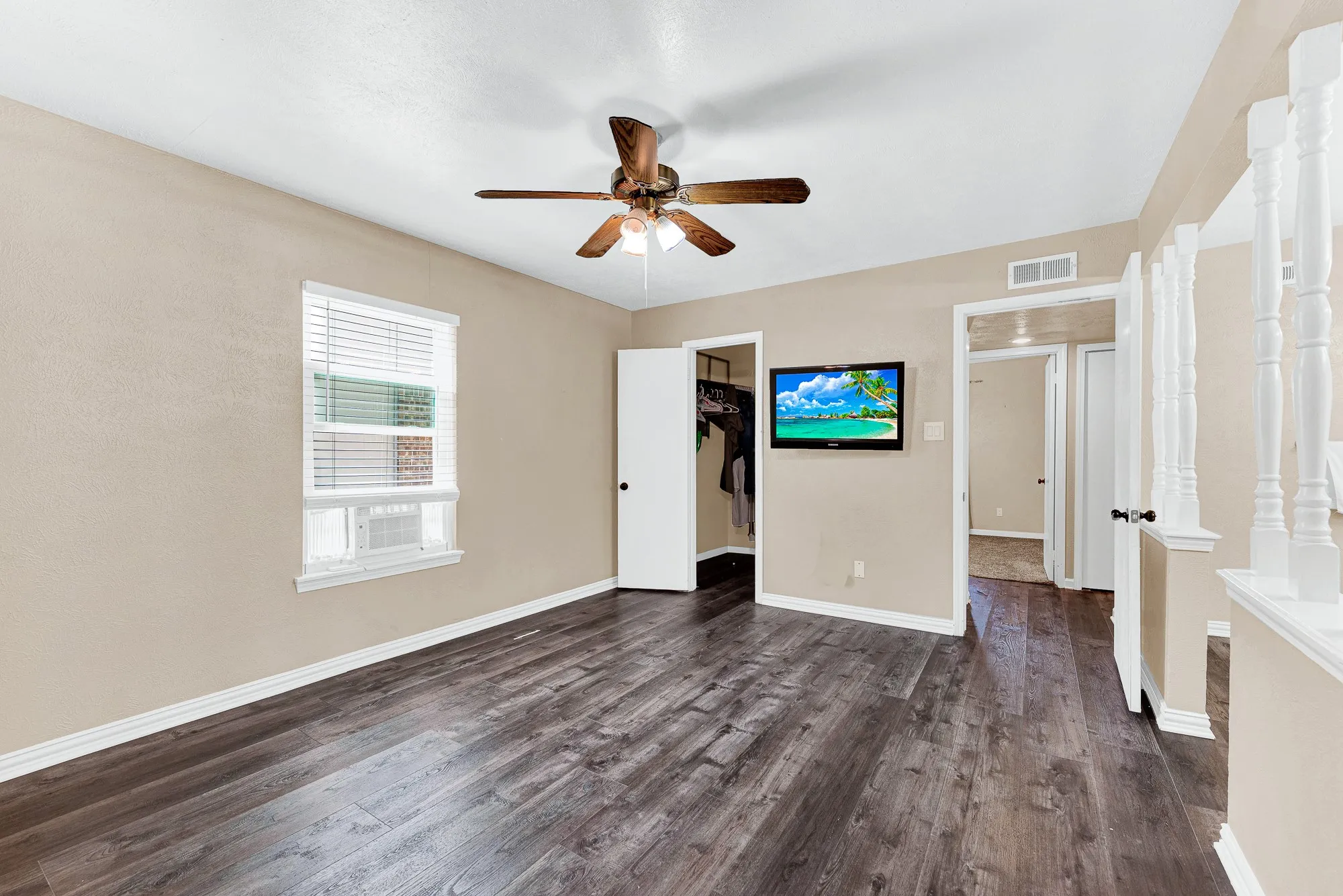 Paved patio area, wood privacy fencing, mature trees, and landscaping