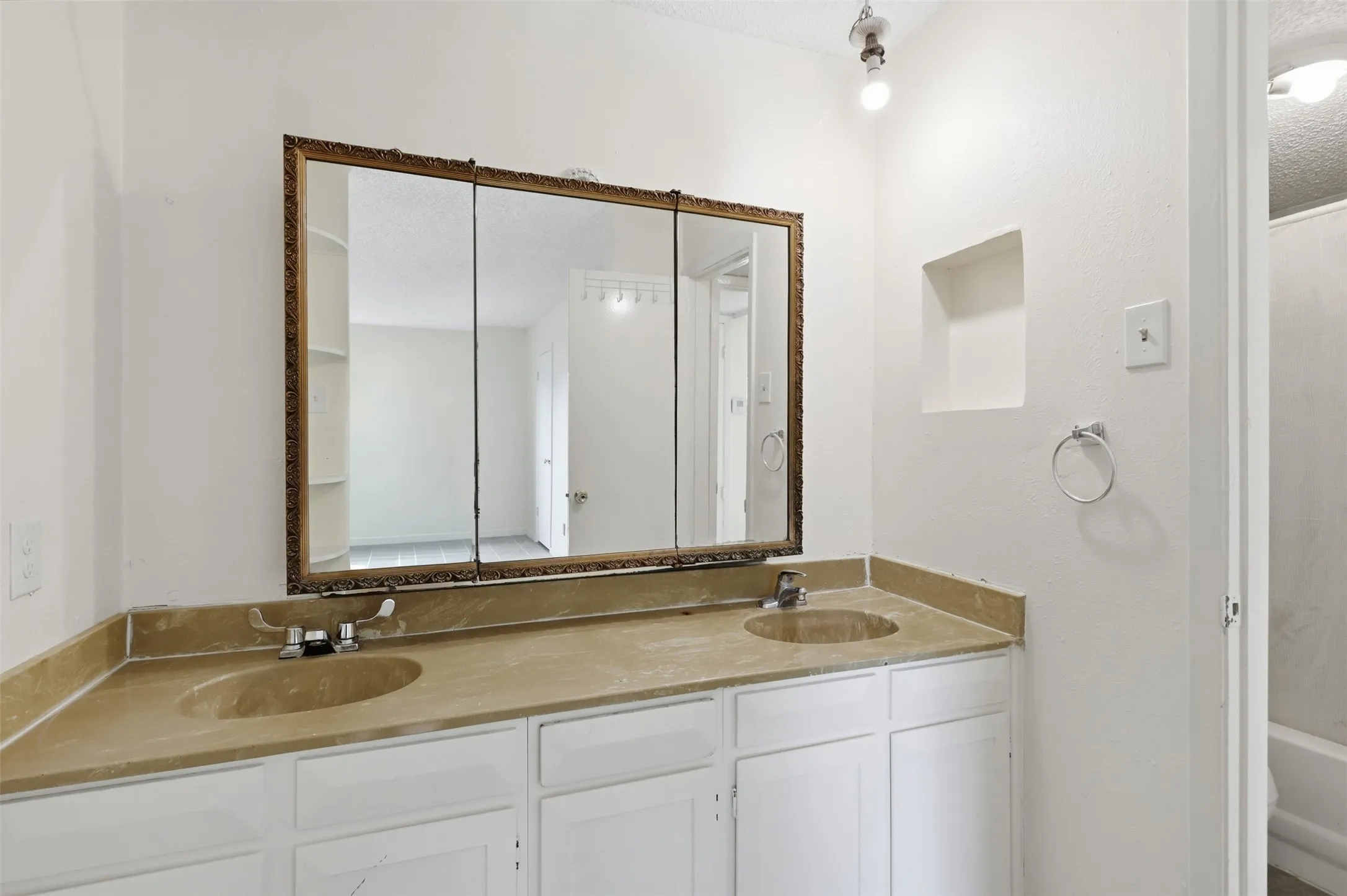 Double vanity with an integrated countertop and white cabinetry