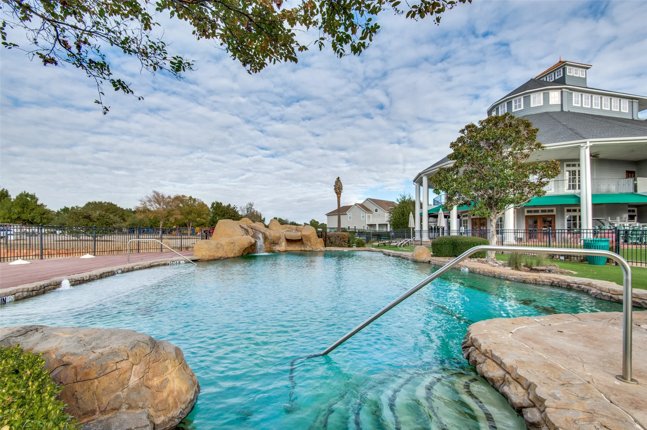 Expansive outdoor pool with rock features and water cascade