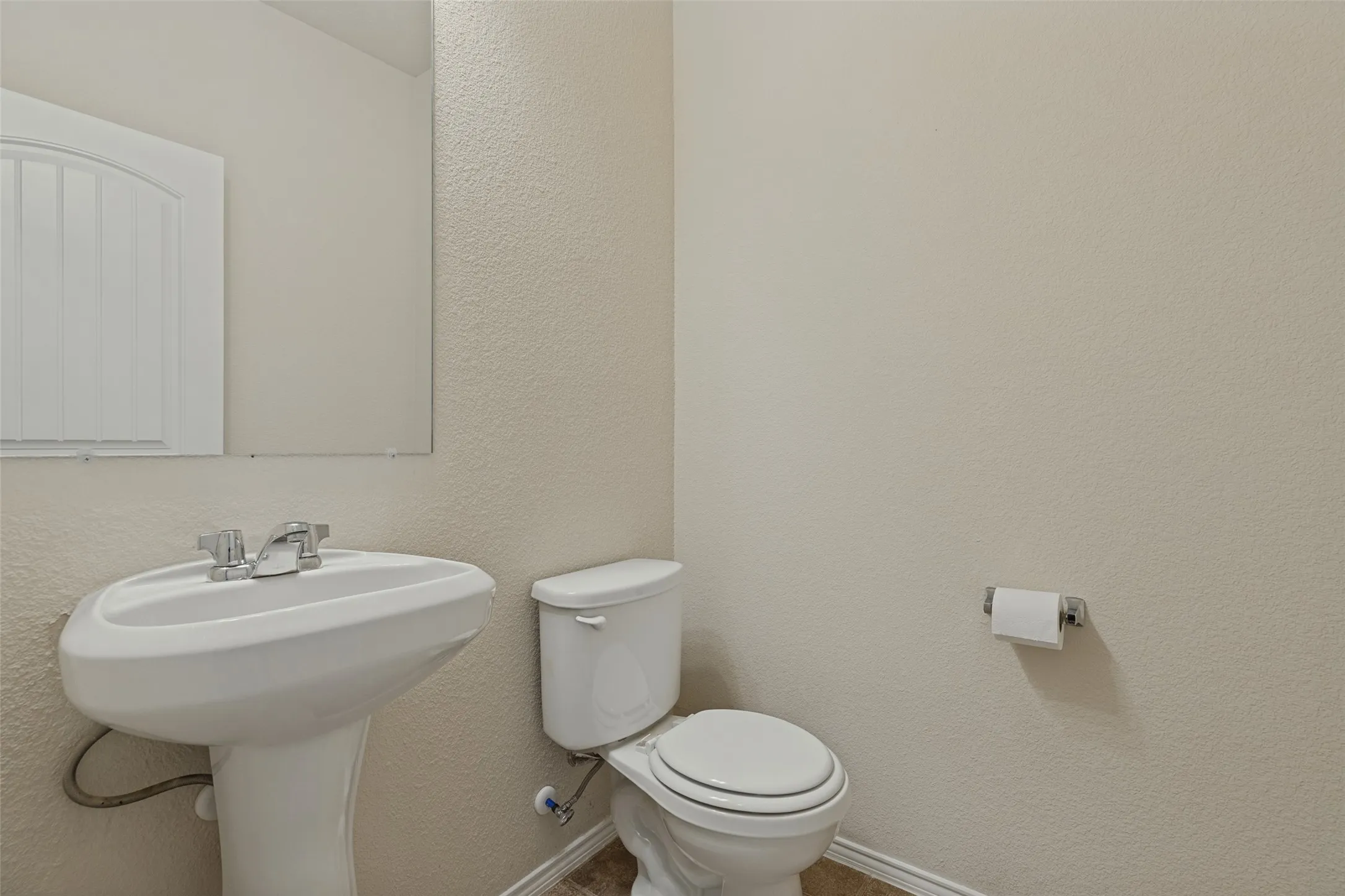 Pedestal sink with chrome faucet, toilet, and wall-mounted​​‌​​​​‌​​‌‌​‌‌​​​‌‌​‌​‌​‌​​​‌​​ mirror