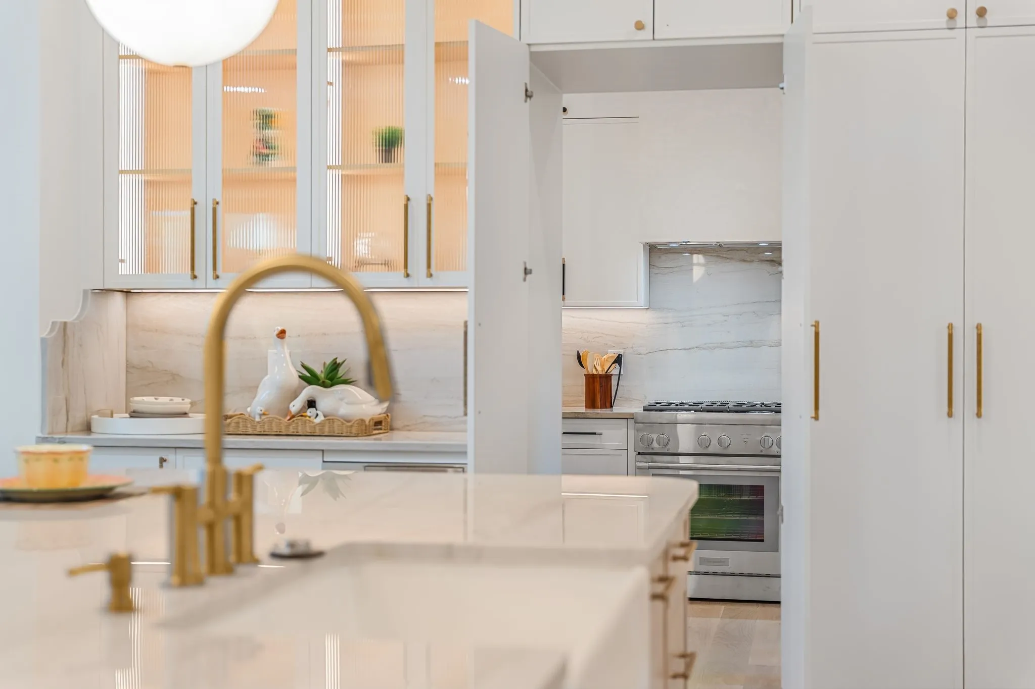 Kitchen island with integrated sink and brass-finish faucet