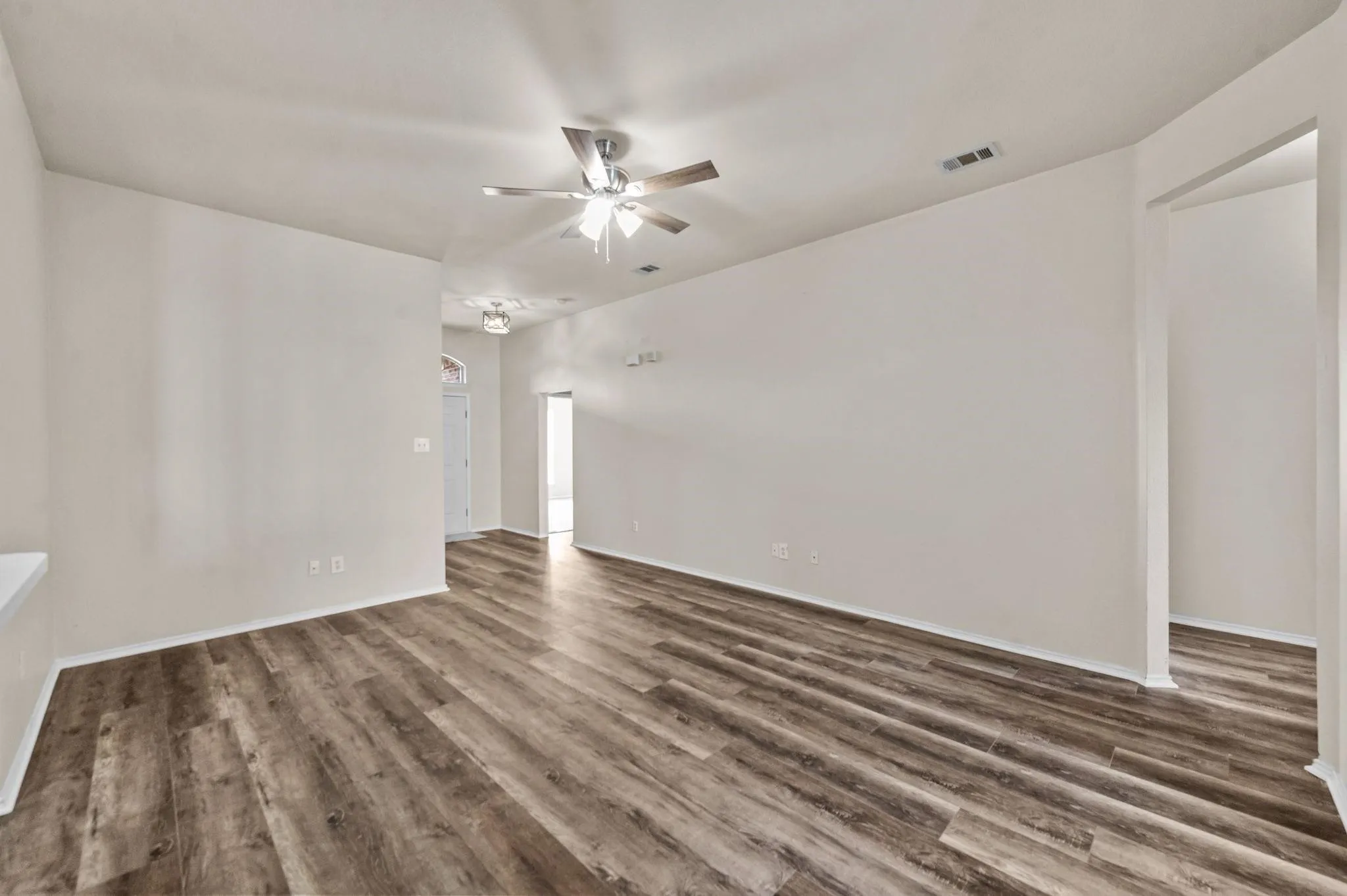 Wood-finish flooring, recessed lighting, and a ceiling fan
