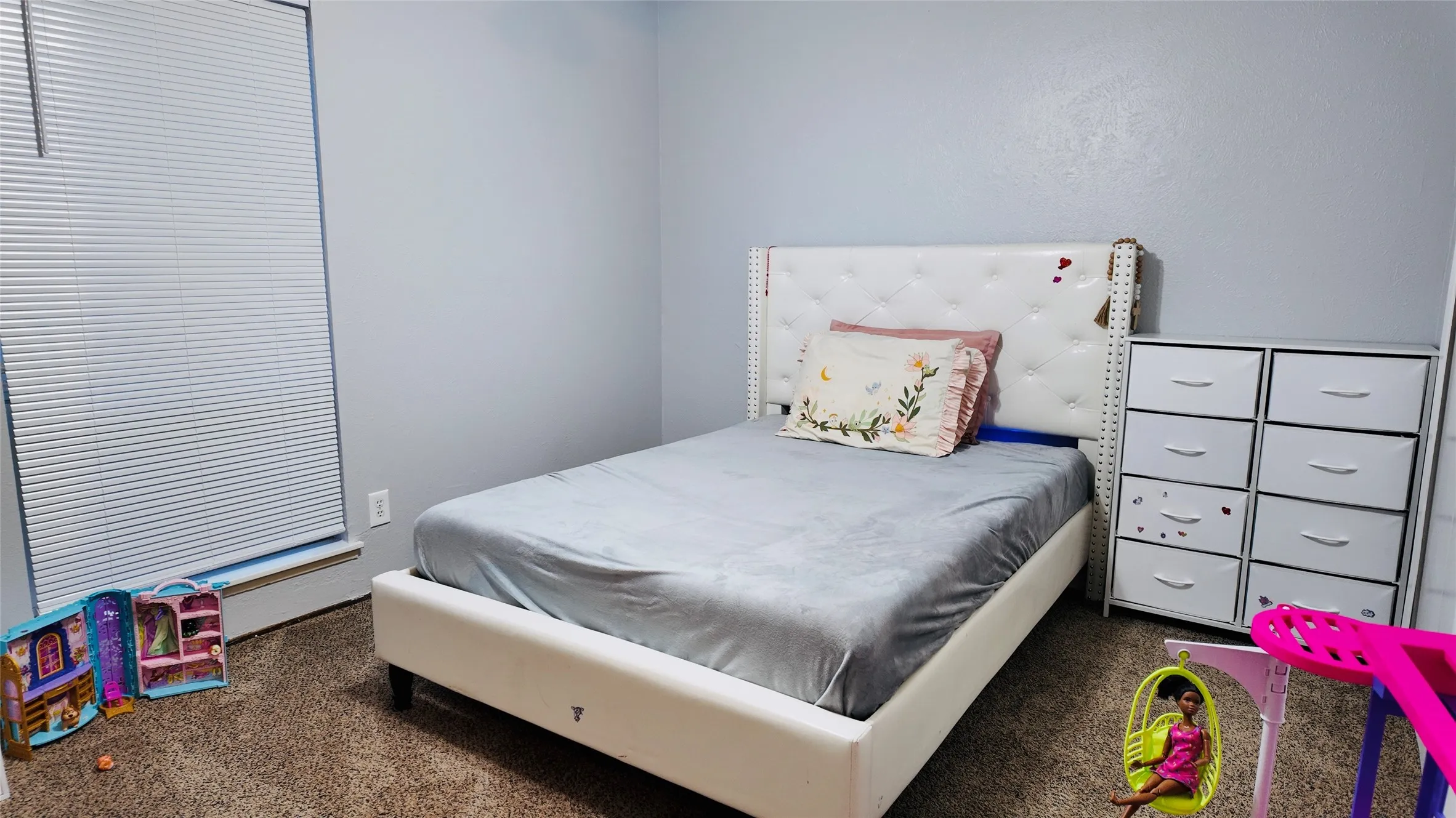 Carpeted flooring, window with blinds, and light gray wall paint