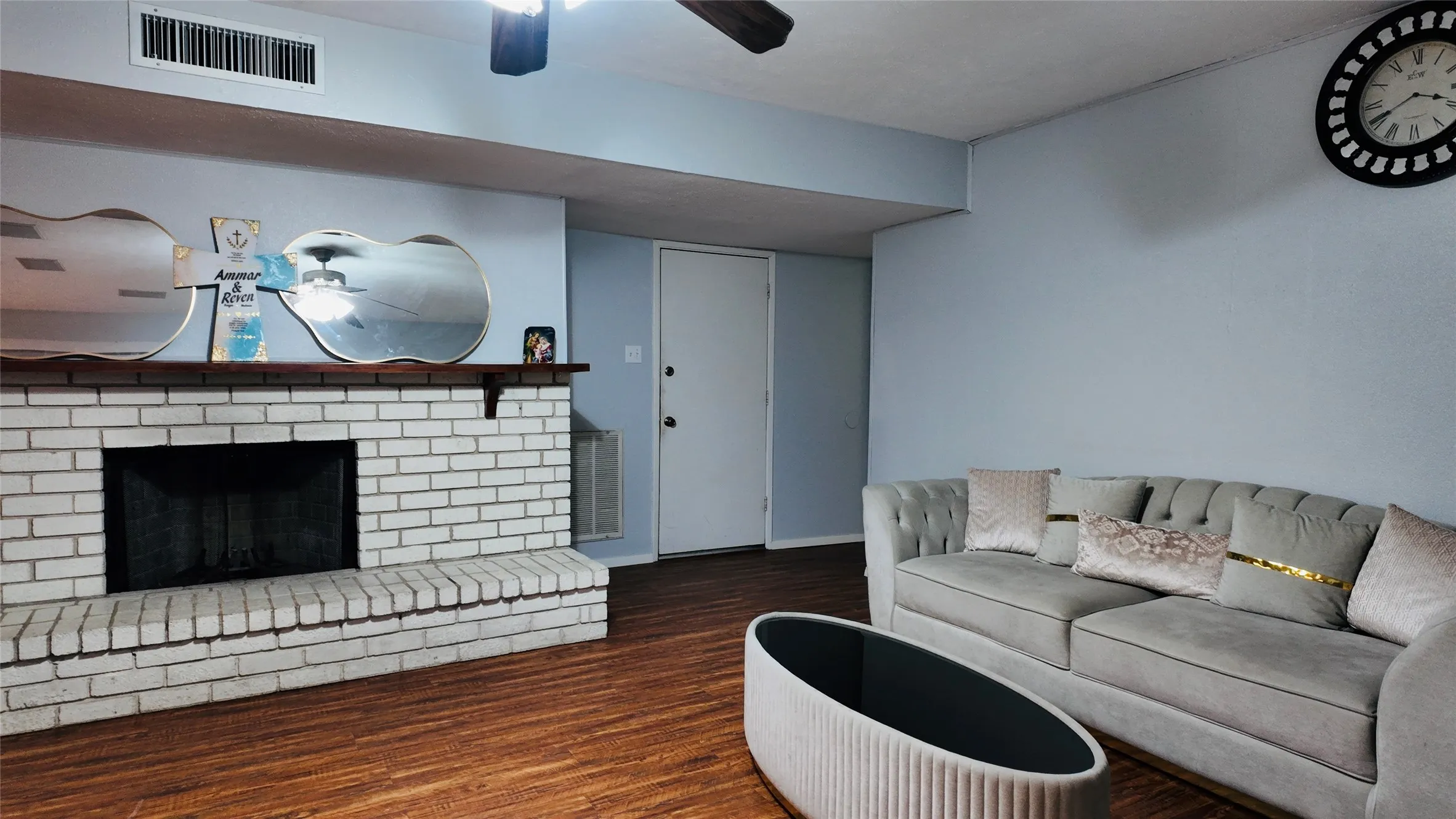 Brick fireplace with a wood mantel
