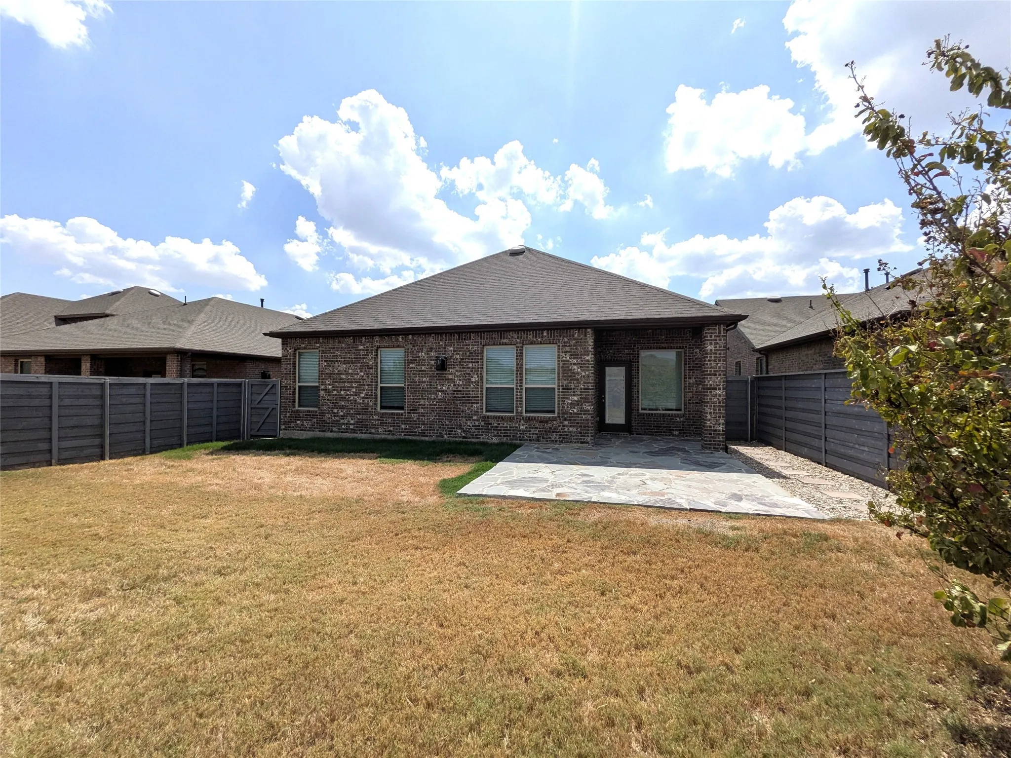 Exterior brick facade with a dark gray roof