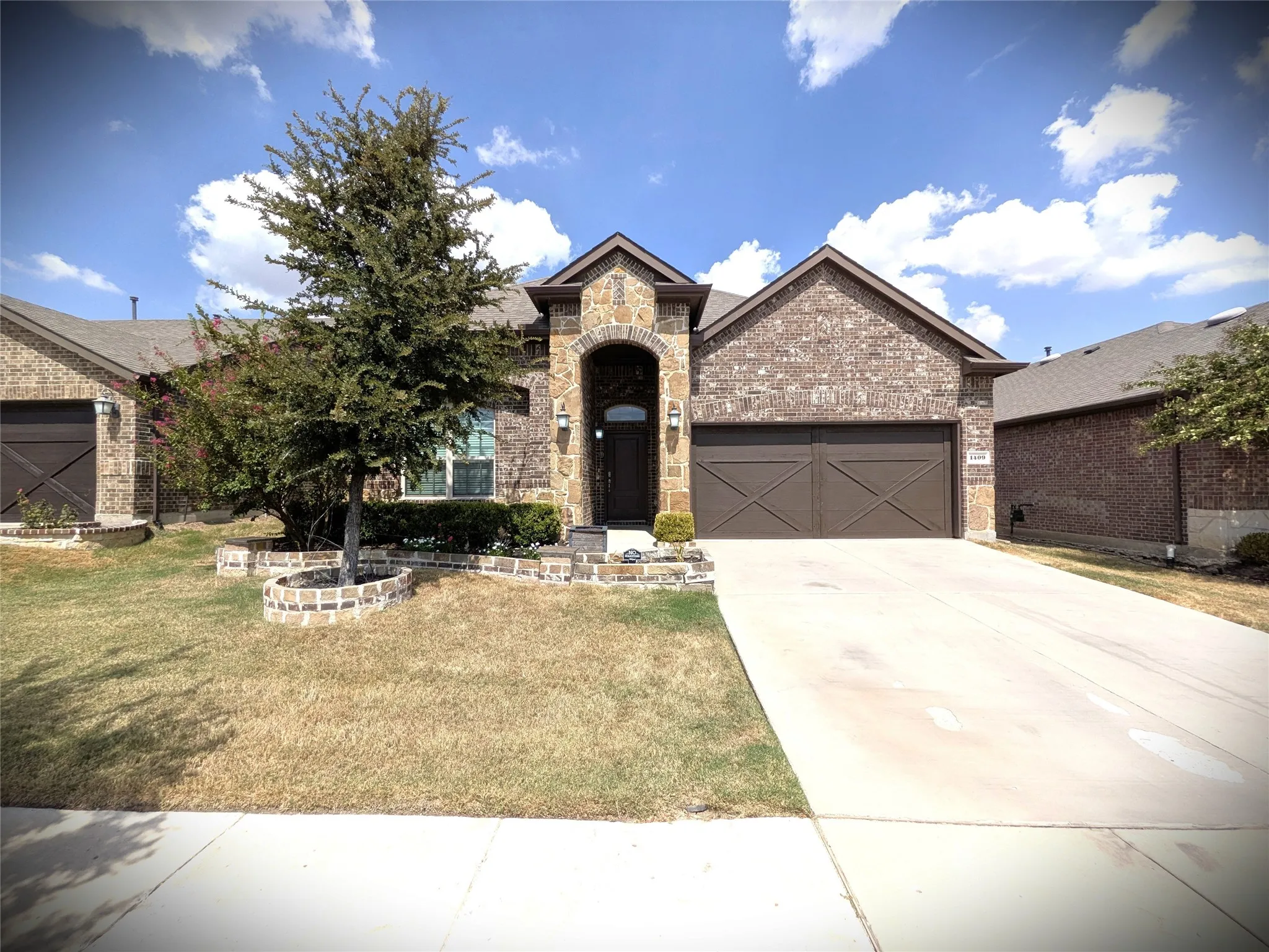 Brick and stone exterior with an arched entry