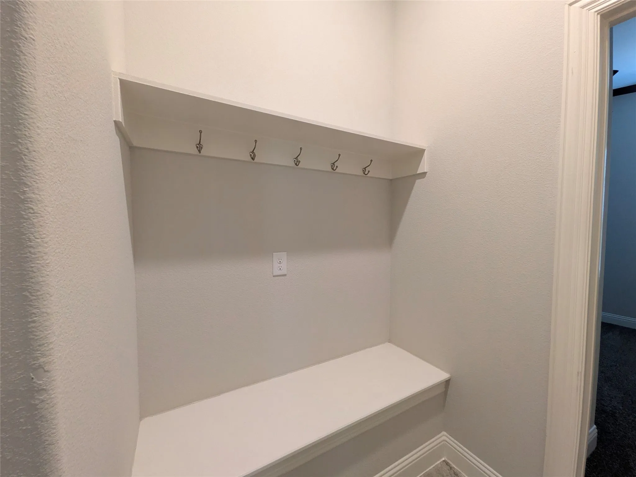 Built-in bench with upper shelving and integrated hooks