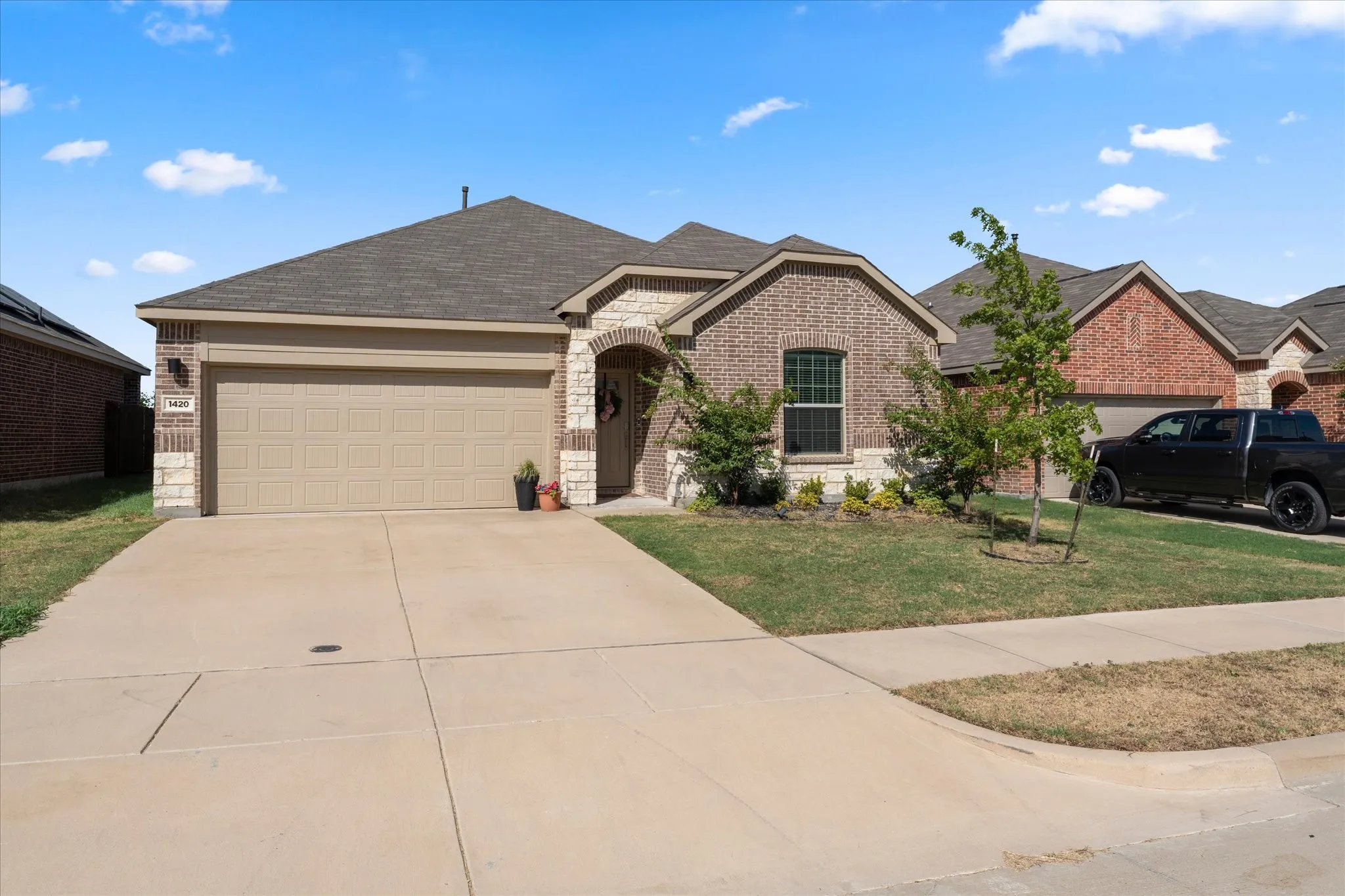 Brick and stone veneer exterior with an arched entry