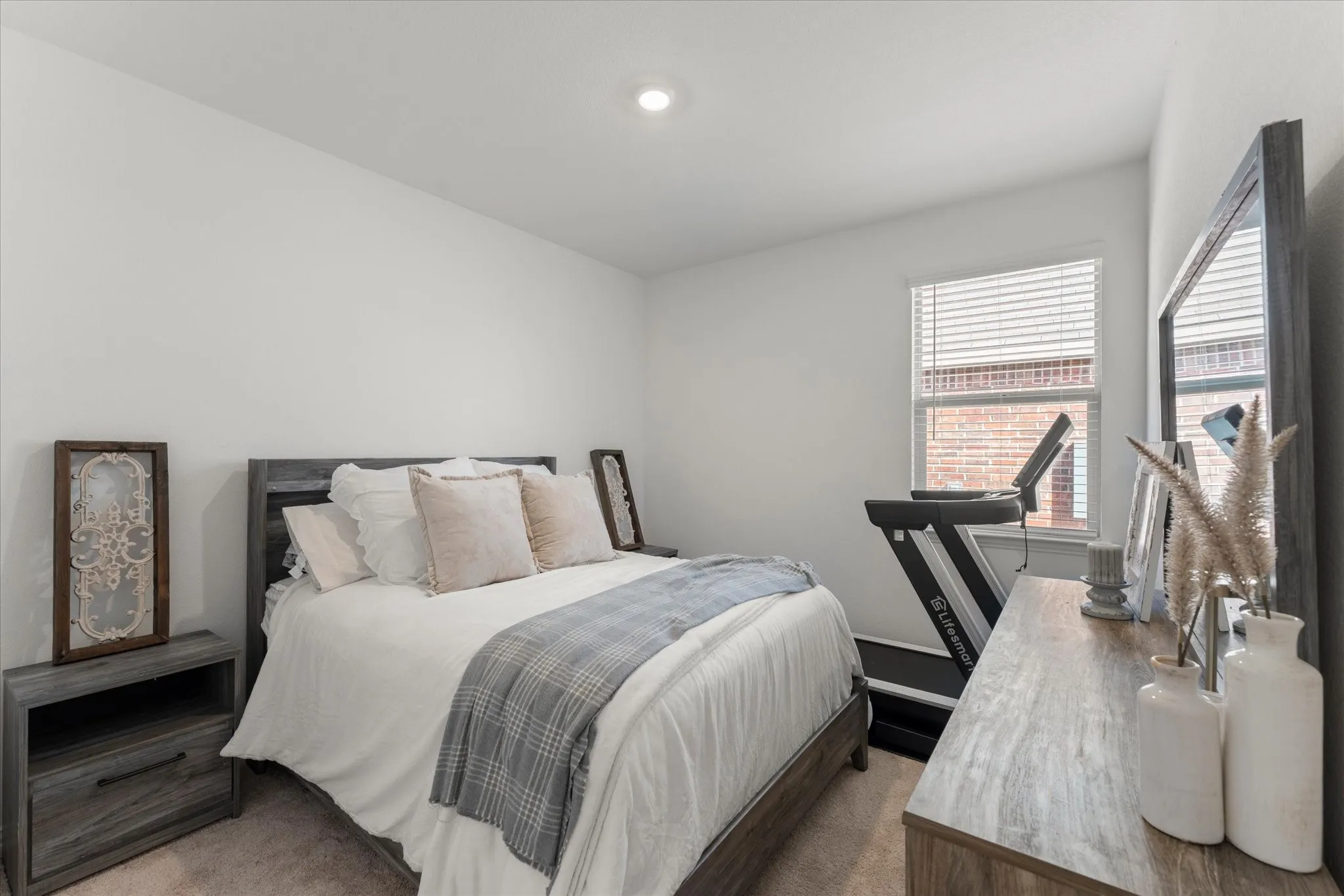 Recessed ceiling lighting, window with blinds, and neutral wall paint