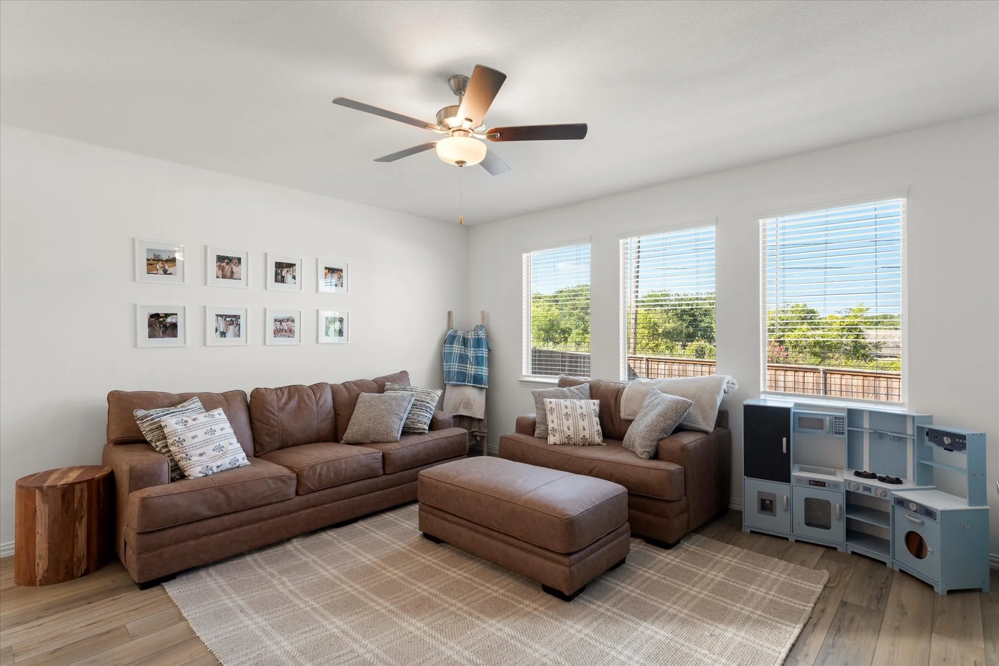 Wood-finish flooring throughout, complemented by a ceiling fan with integrated lighting