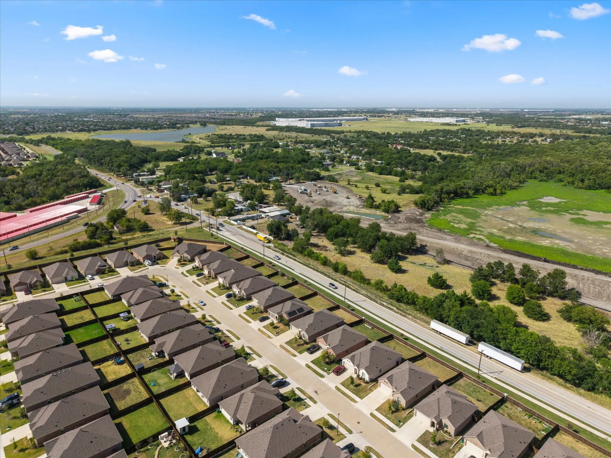 Aerial perspective of a developed residential community with dark-toned roofs