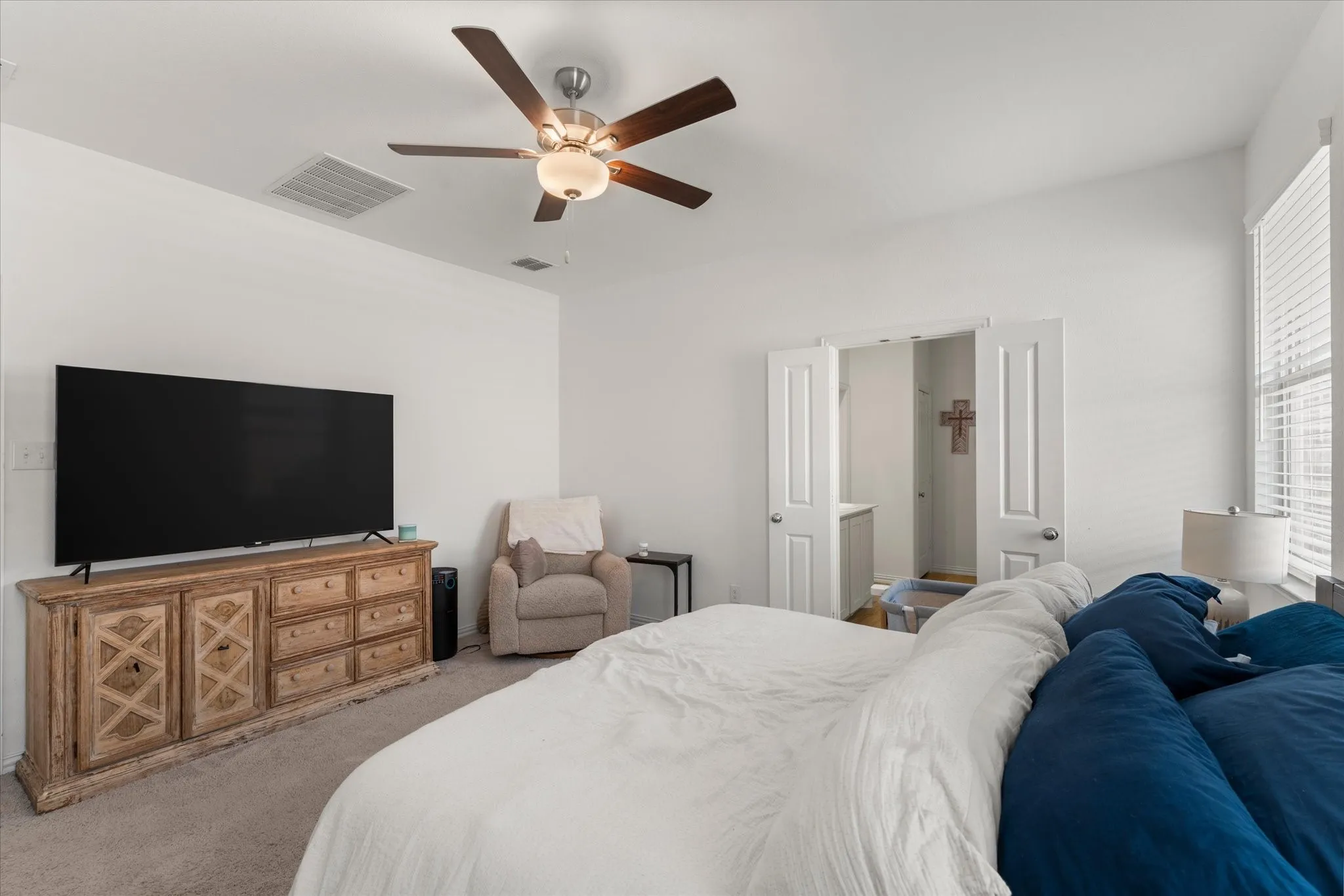 Vaulted ceilings with a ceiling fan, window with blinds, and white interior doors