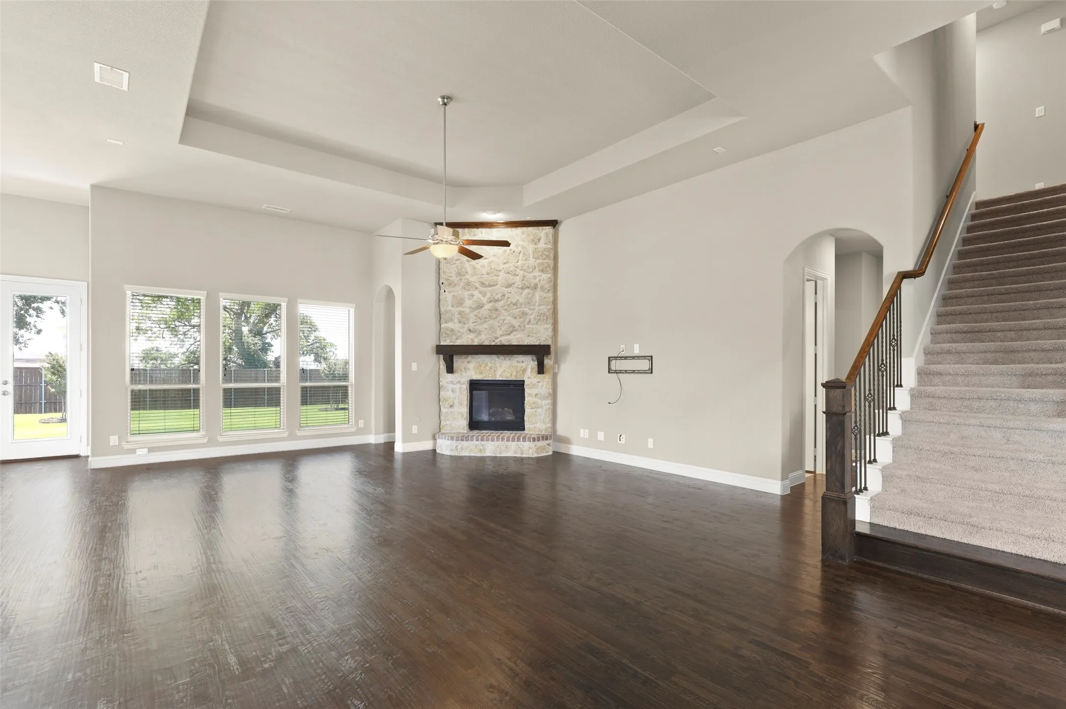 Open concept living with stone fireplace