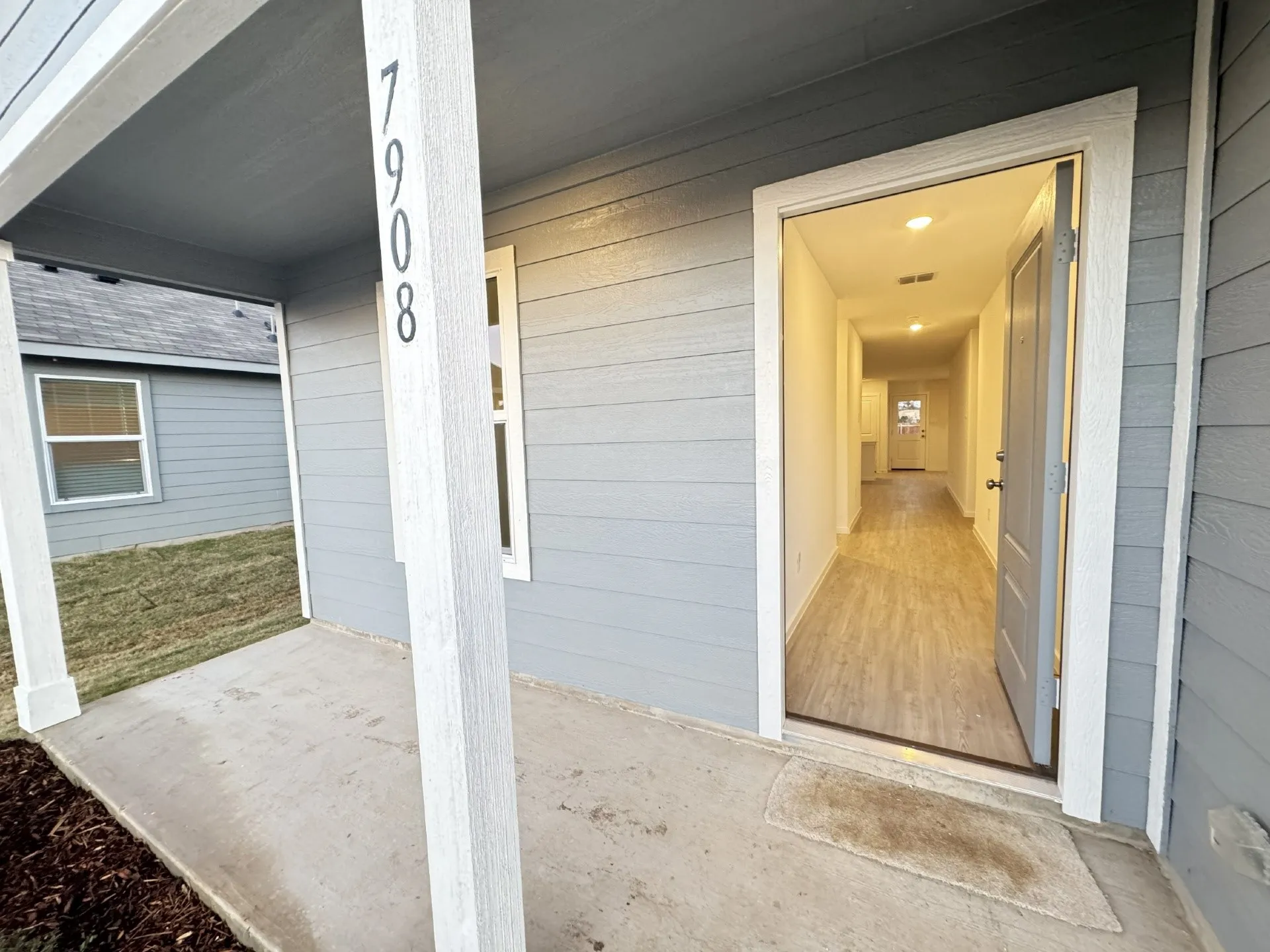 Siding exterior with a covered concrete porch