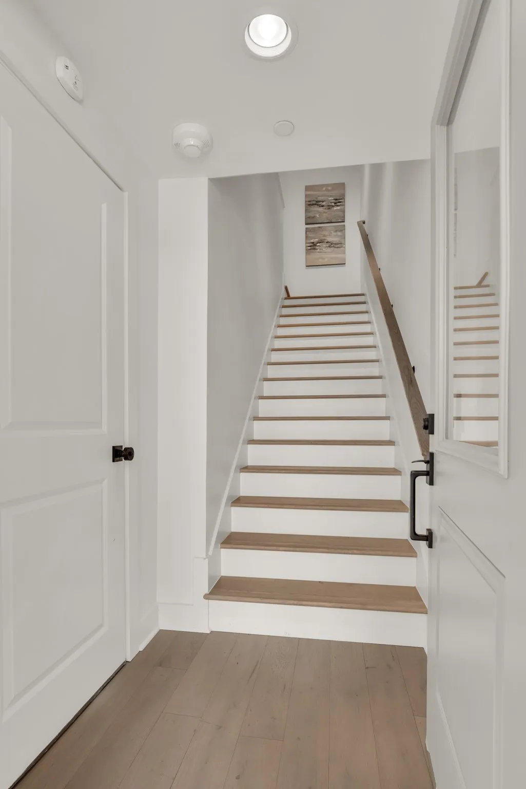 Stairs featuring wood-type flooring