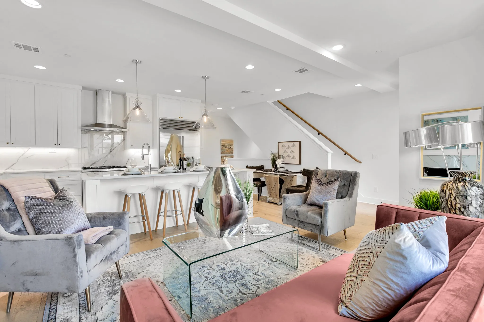 Living room featuring light wood-style floors, recessed lighting, and stairs