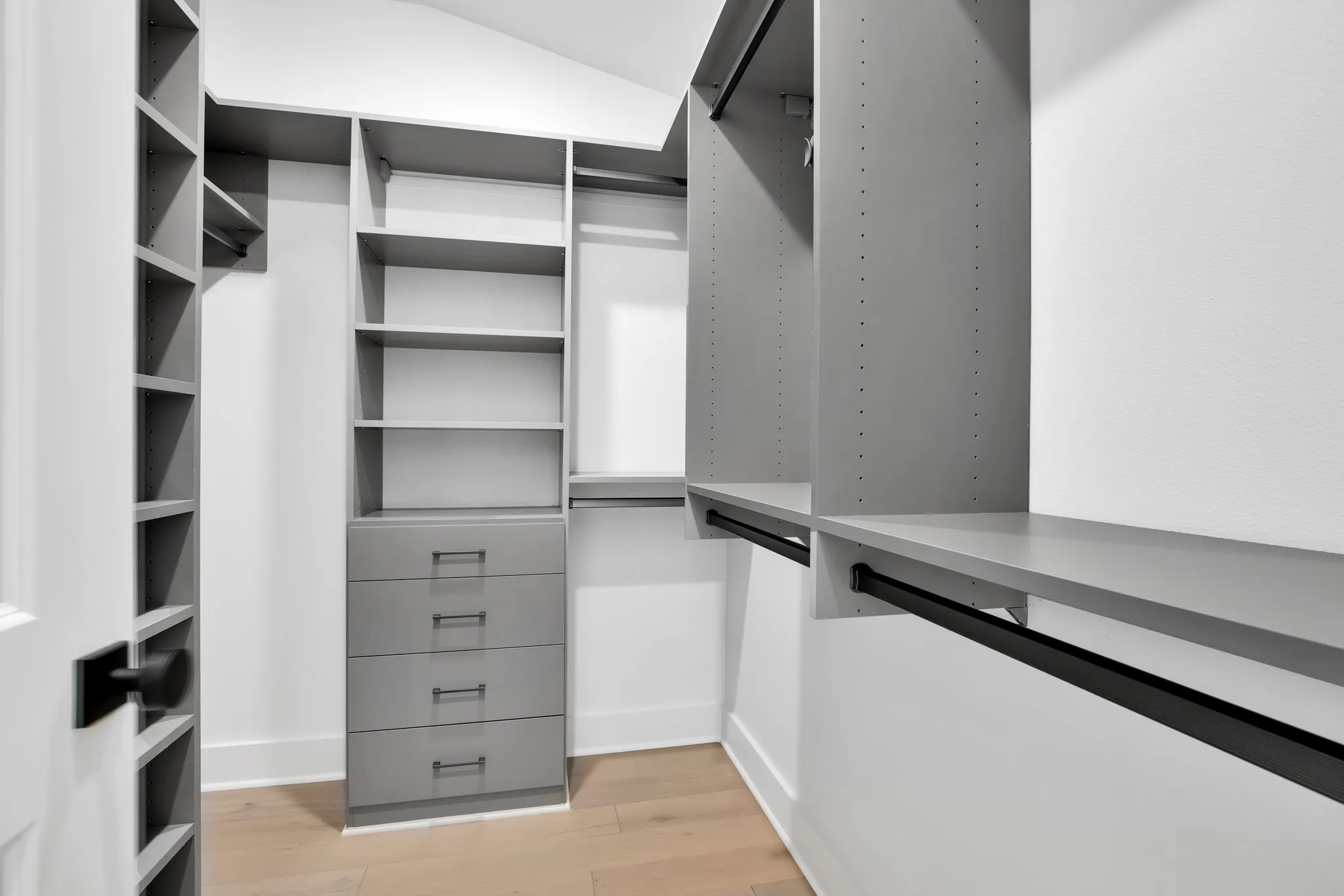 Spacious closet with light wood finished floors