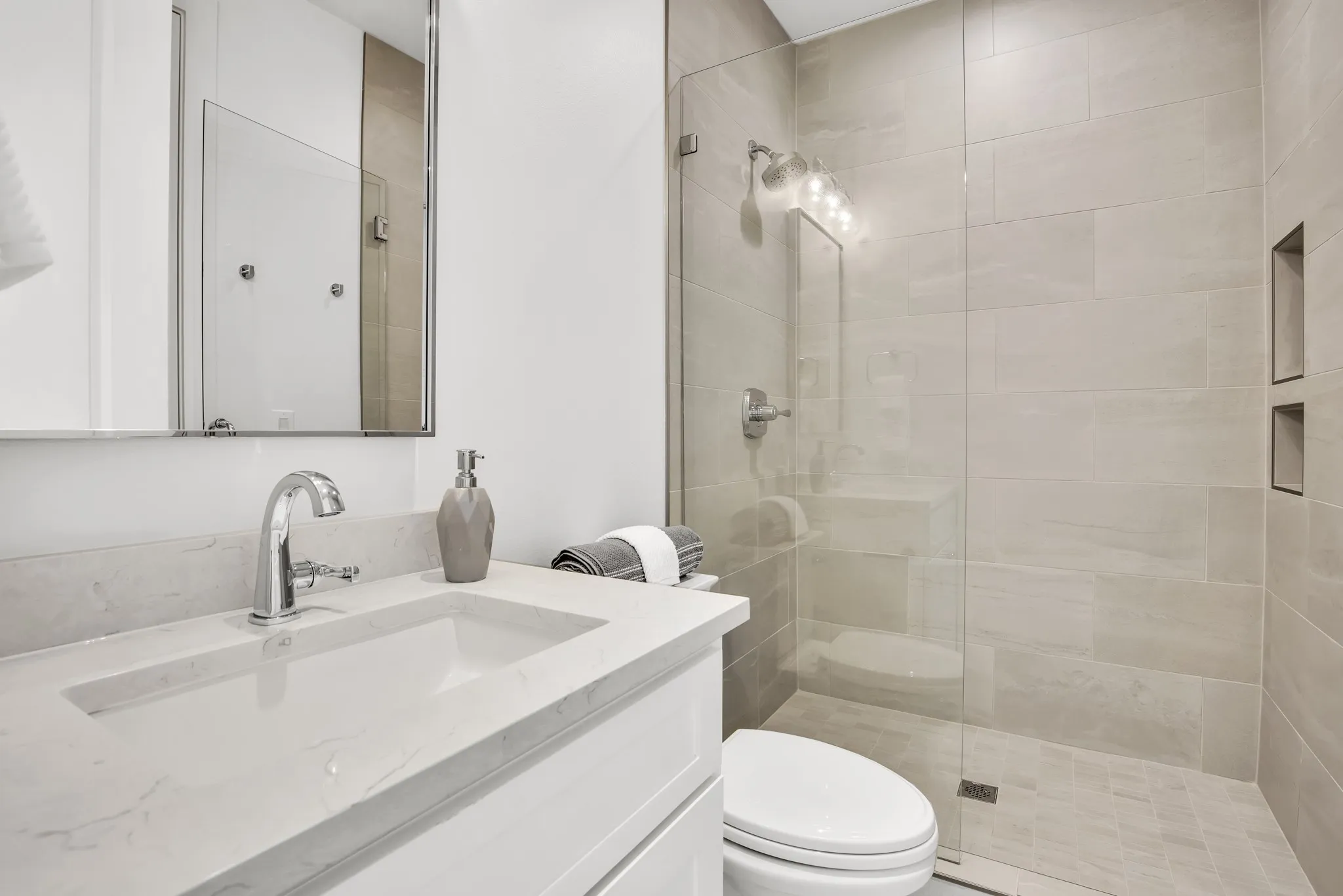 Full bathroom with vanity and a stall shower