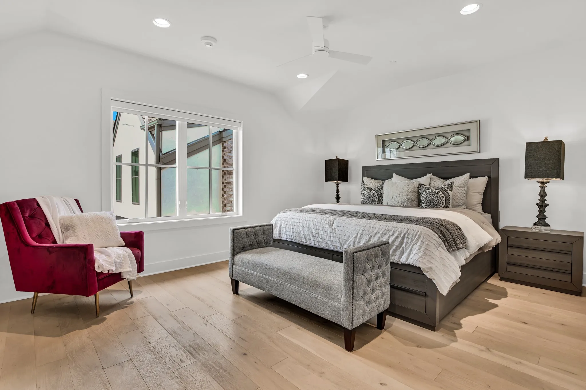 Bedroom featuring recessed lighting, vaulted ceiling, light wood-style floors, and a ceiling fan